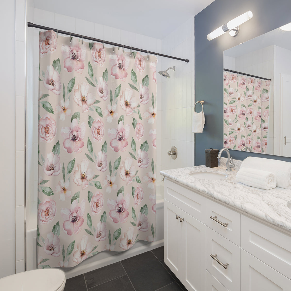 A bathroom with a white vanity, a shower curtain with a floral pattern, and a mirror above the vanity.