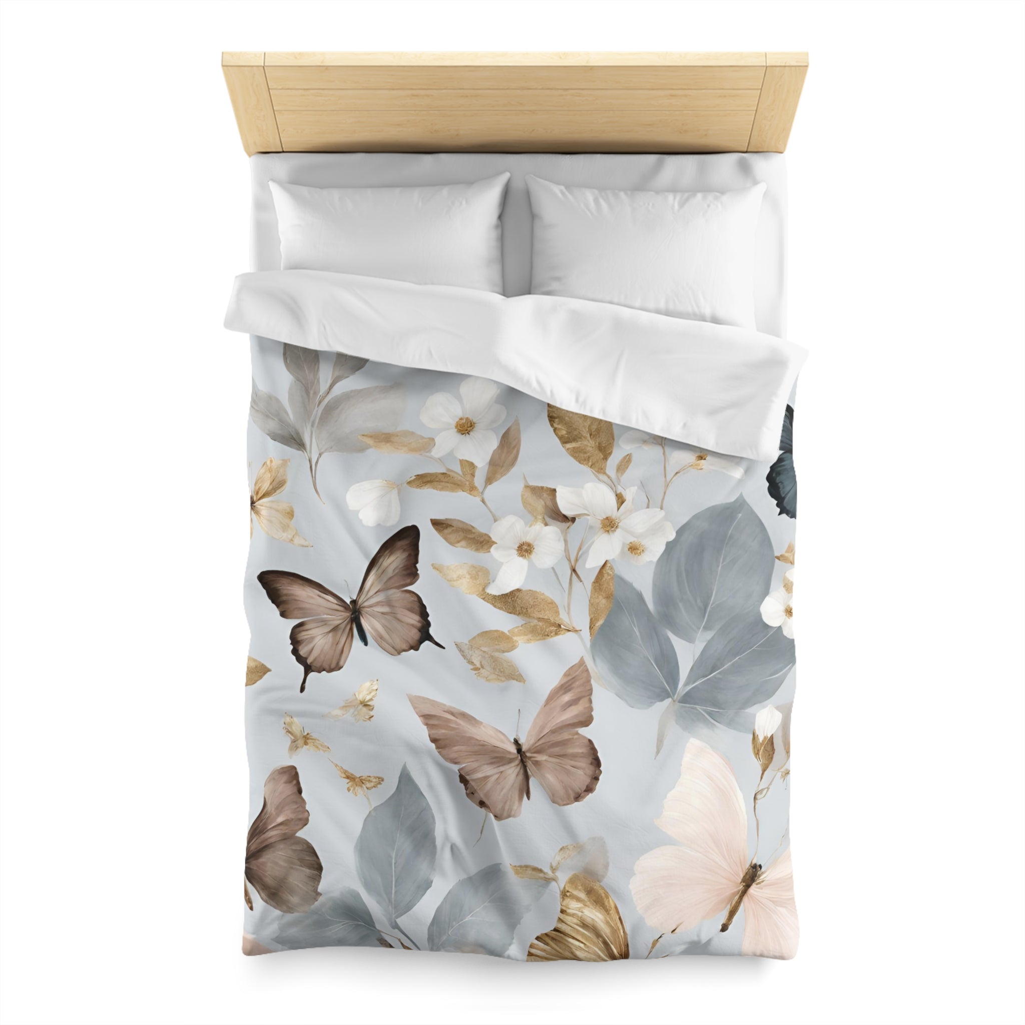 a bed with a white comforter and pillows, featuring a floral print design with butterflies and leaves in shades of gray, white, and brown.