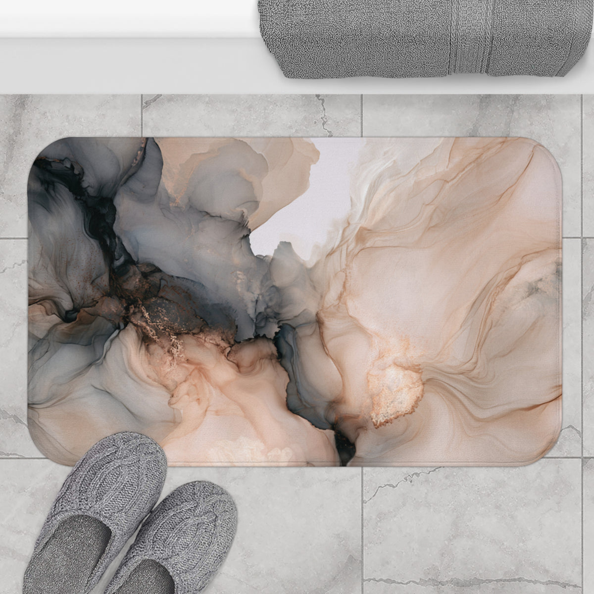 a bathroom mat with an abstract, swirling design in shades of brown and beige. The mat is placed on a tiled floor, and there are gray slippers positioned next to it.