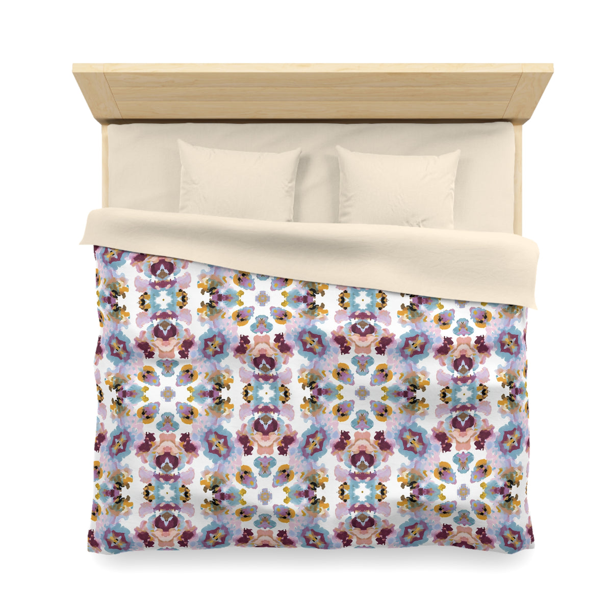 a bed with a colorful, patterned comforter and pillows.
