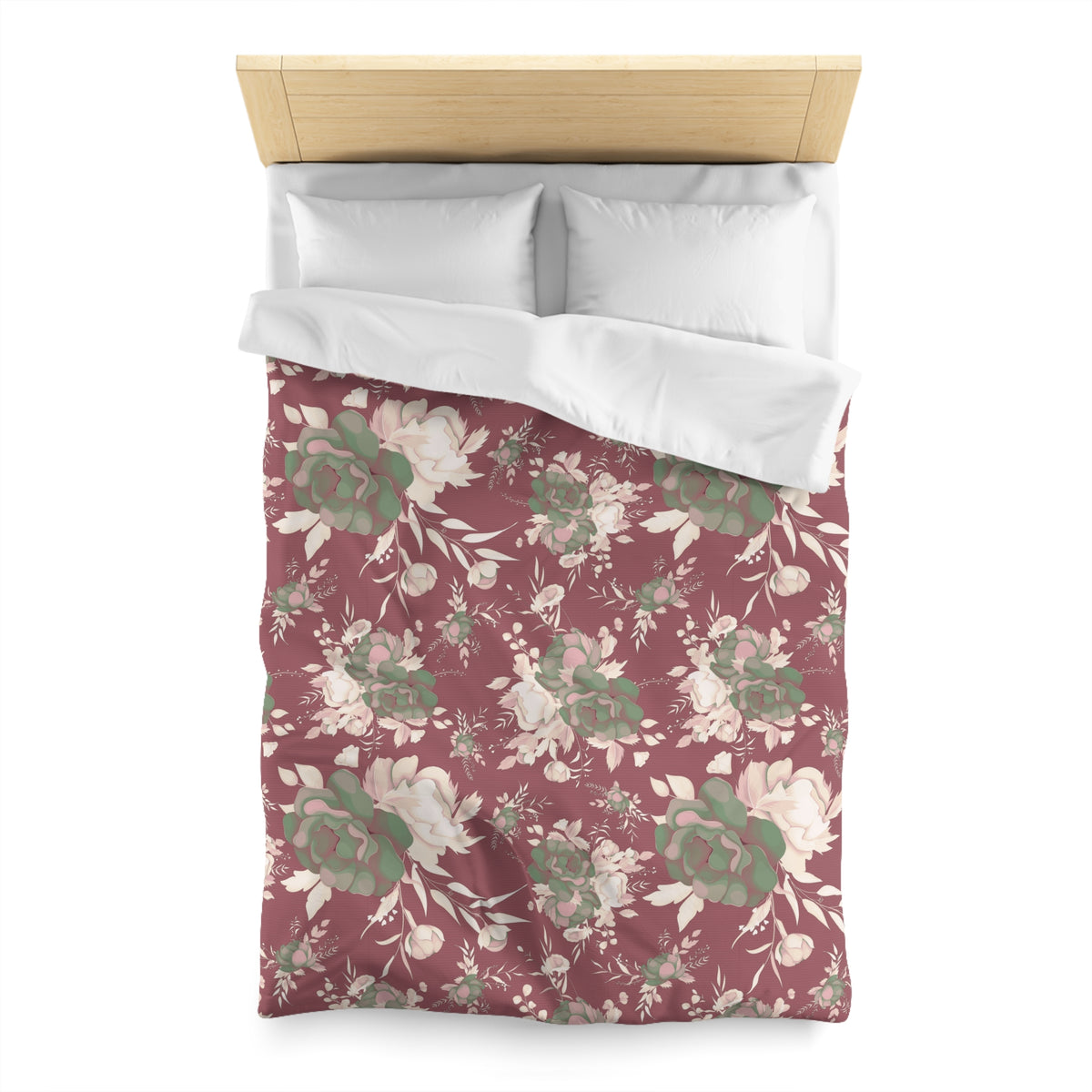 a bed with a floral patterned comforter and pillows.