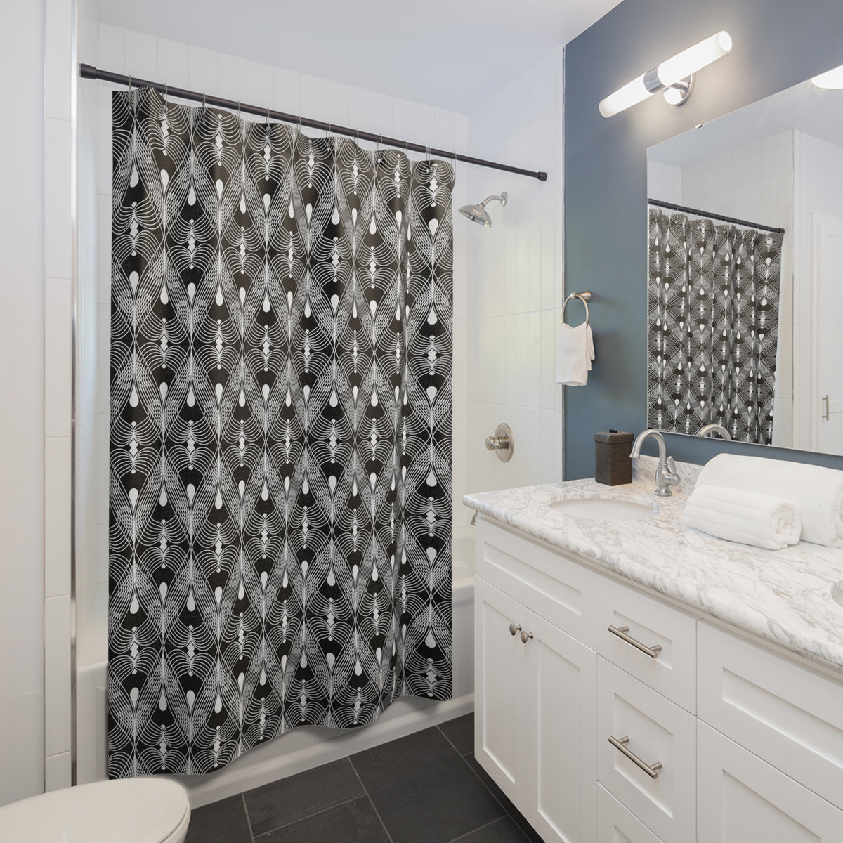 a modern bathroom with a white vanity, a black and white patterned shower curtain, and a mirror above the vanity.