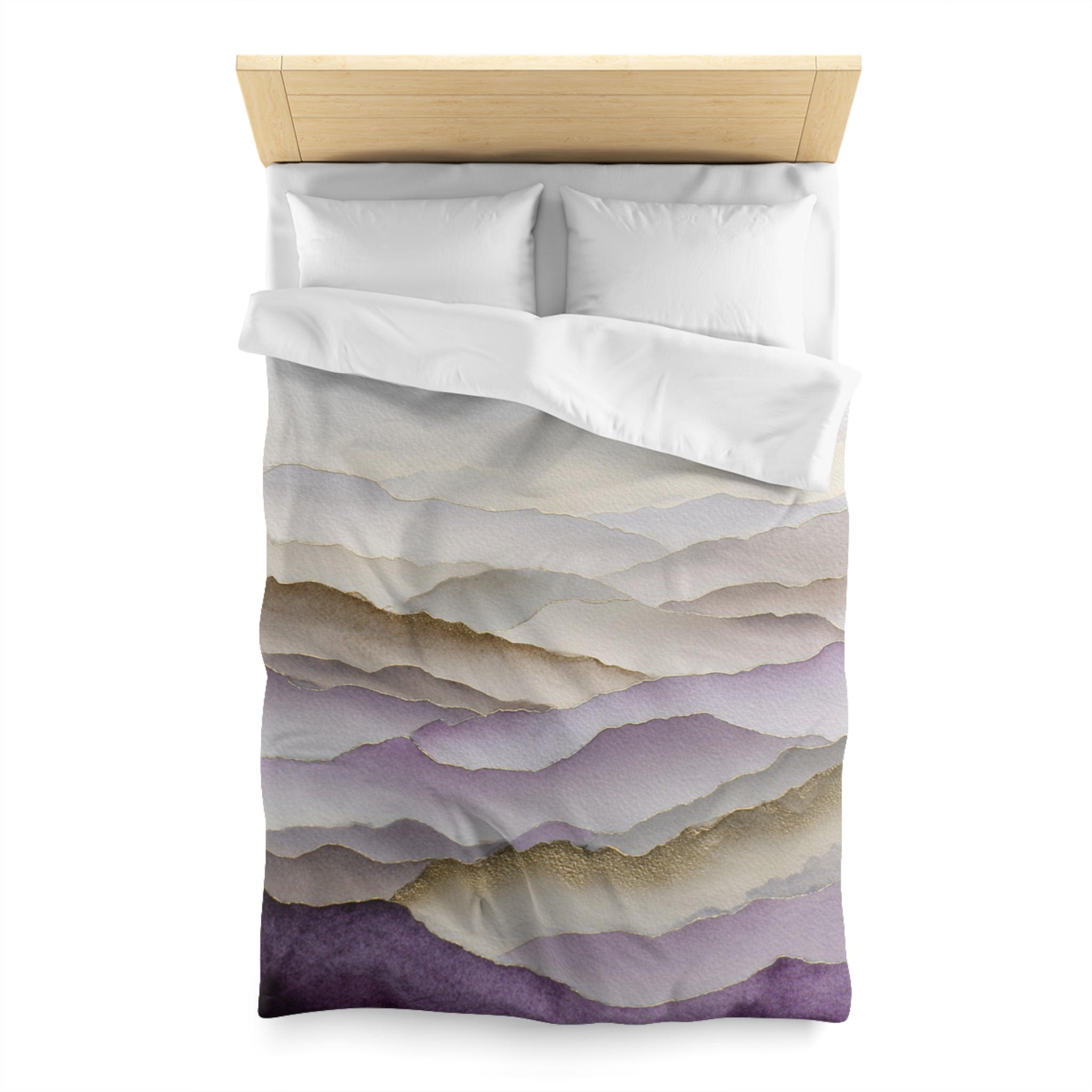 a bed with a white comforter and pillows, featuring a printed design of hills or mountains in shades of purple and gray.
