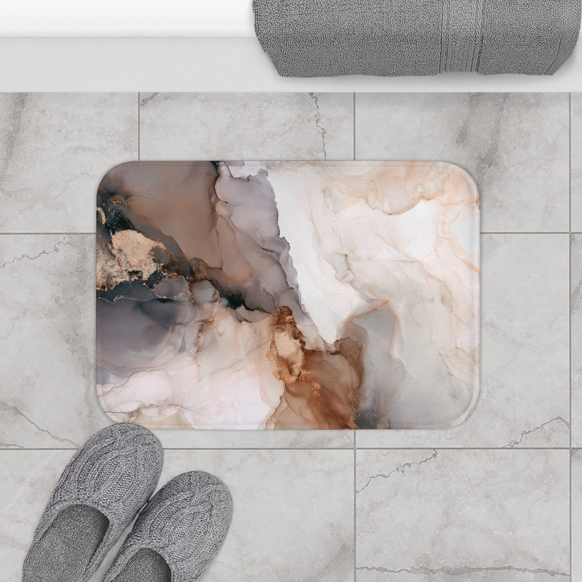 a bathroom scene with a marble-like pattern on a bath mat, gray slippers placed on the floor, and a towel rolled up on a towel rack.