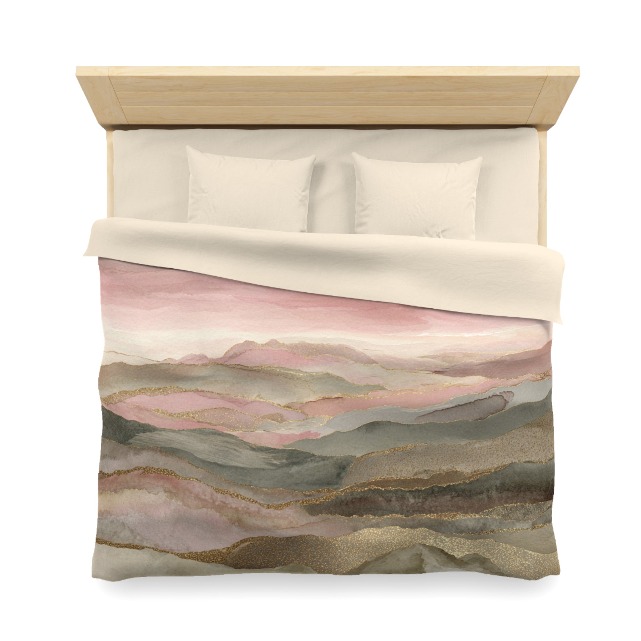 a bed with a pink and brown watercolor-style comforter and pillows.