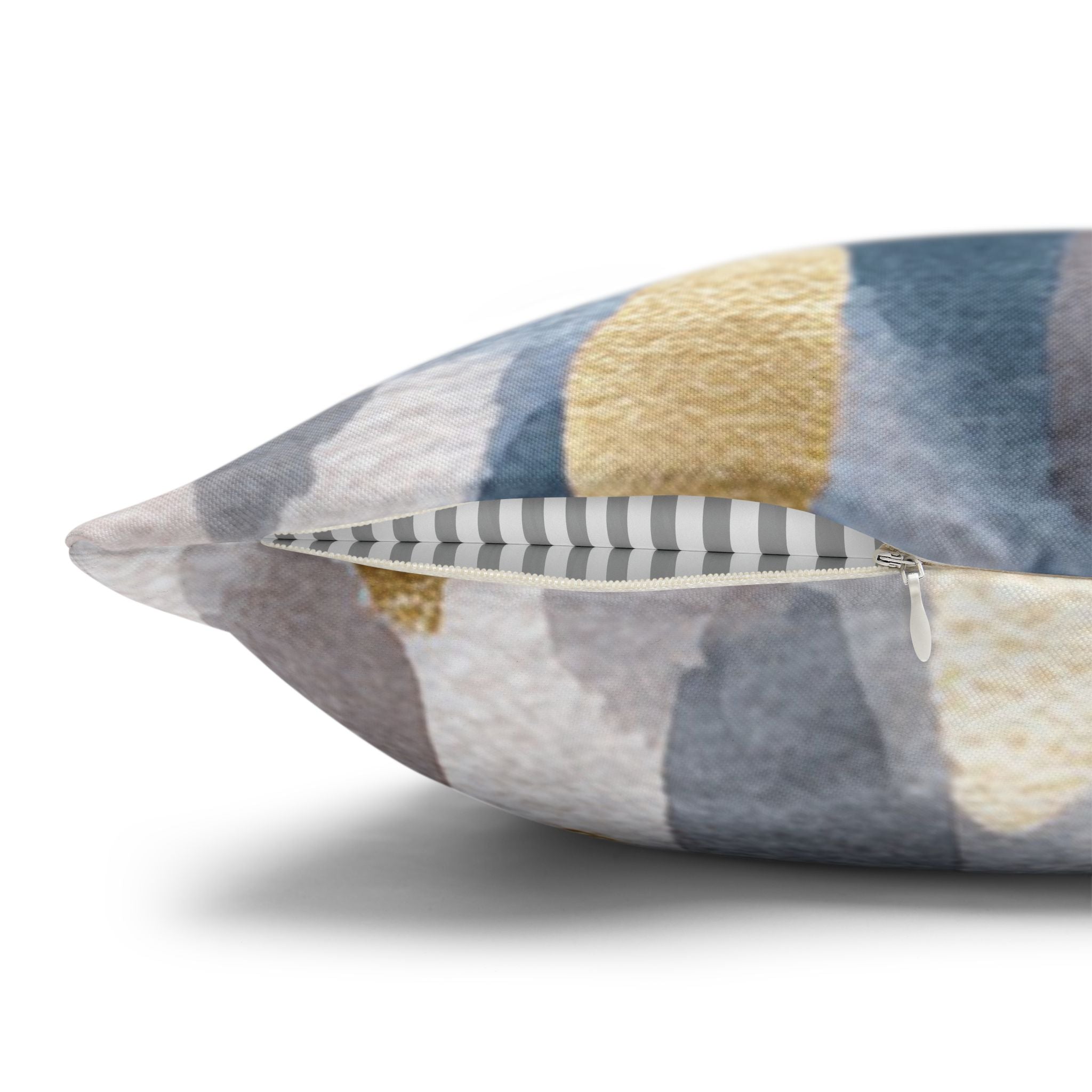 a close-up view of a decorative pillow with a striped pattern in shades of gray and yellow.