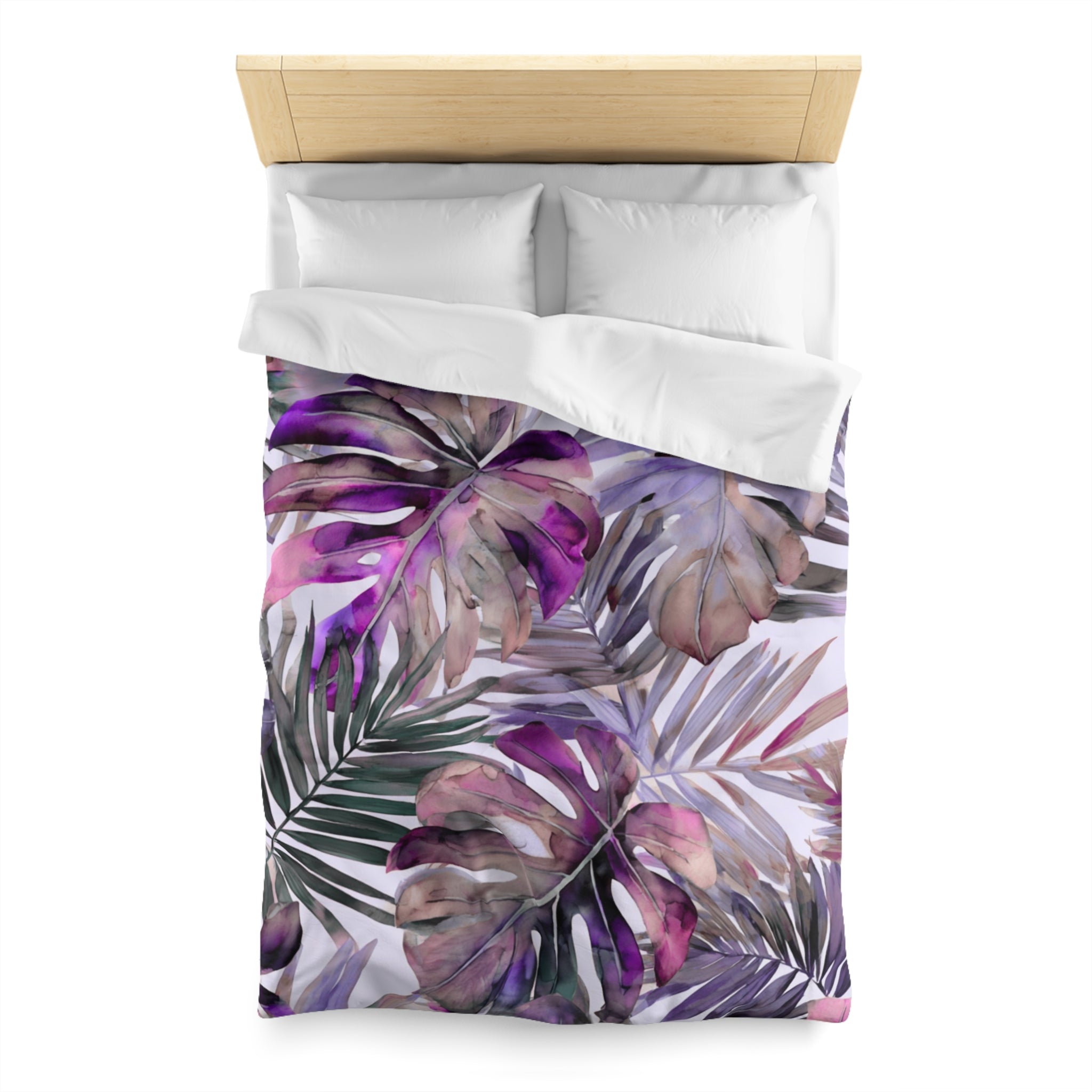 a bed with a colorful, tropical-themed bedspread featuring large, vibrant leaves in shades of purple and green.