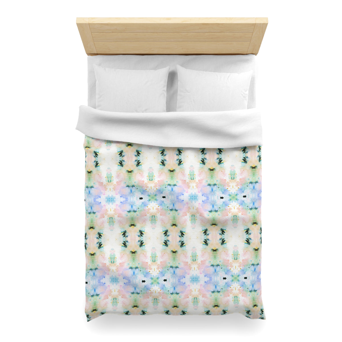 a bed with a colorful, patterned comforter and pillows.