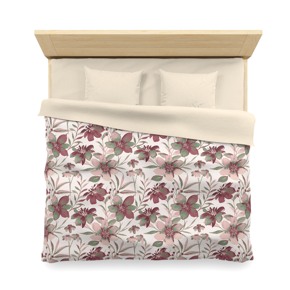 a neatly made bed with a floral patterned comforter and pillows.