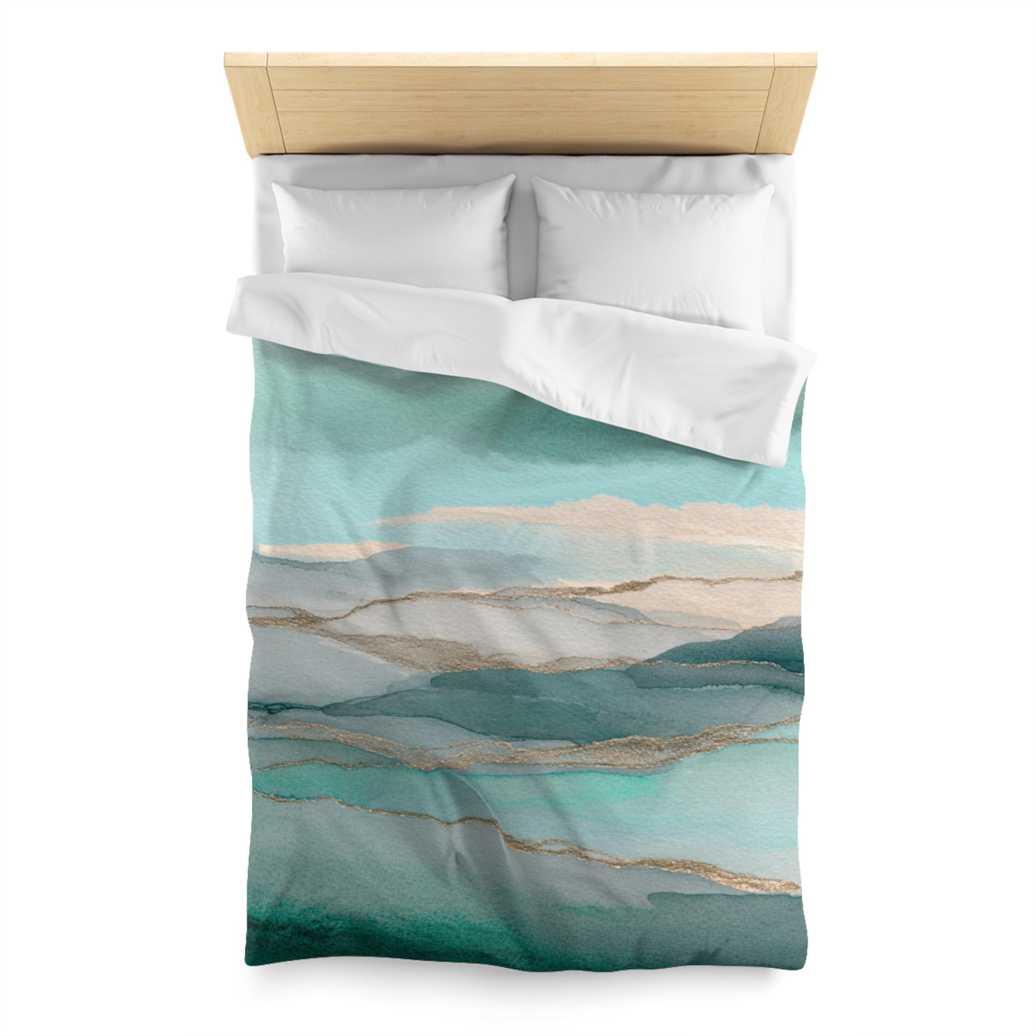 a bed with a blue and green watercolor-style comforter and pillows.