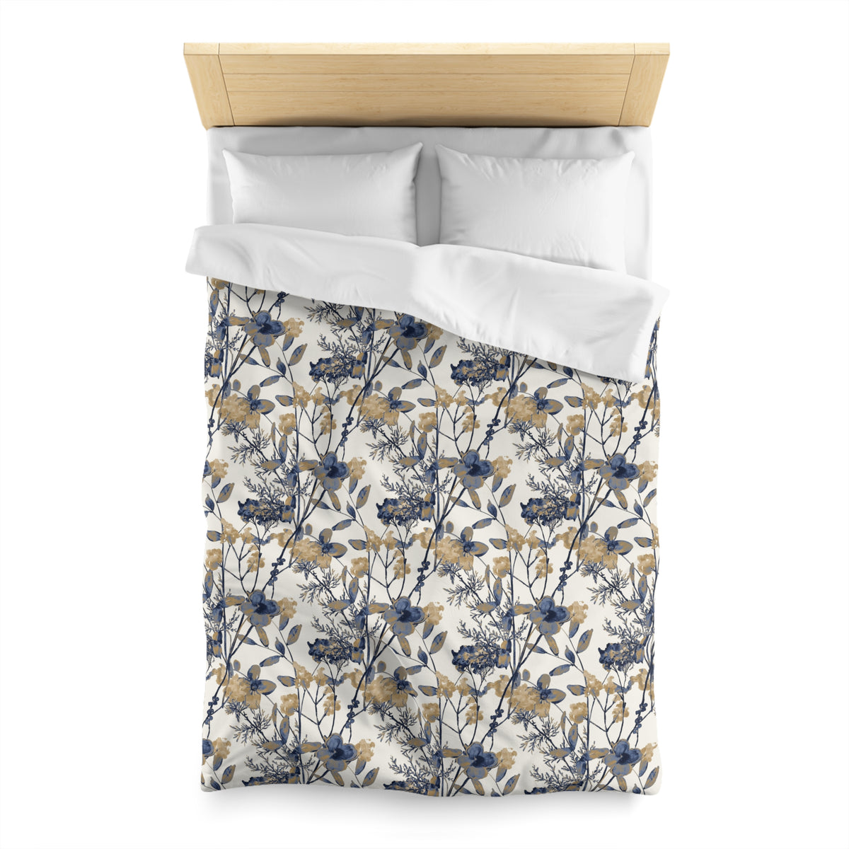 a neatly made bed with a floral print duvet cover and two white pillows.