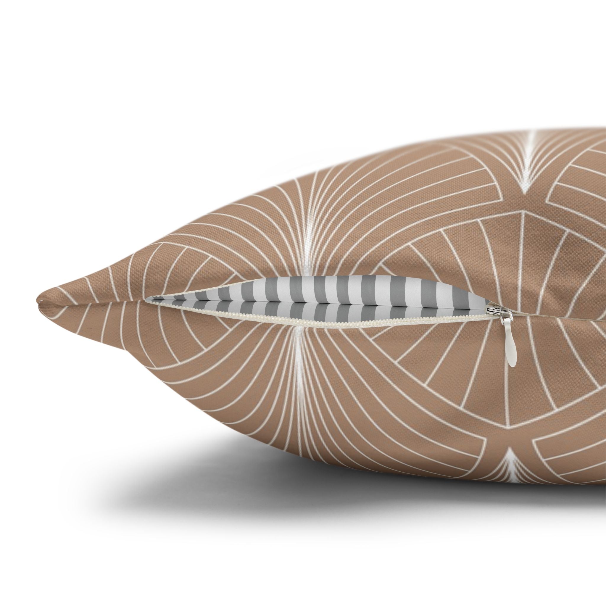 a close-up view of a brown and white patterned pillow with a zipper pull.