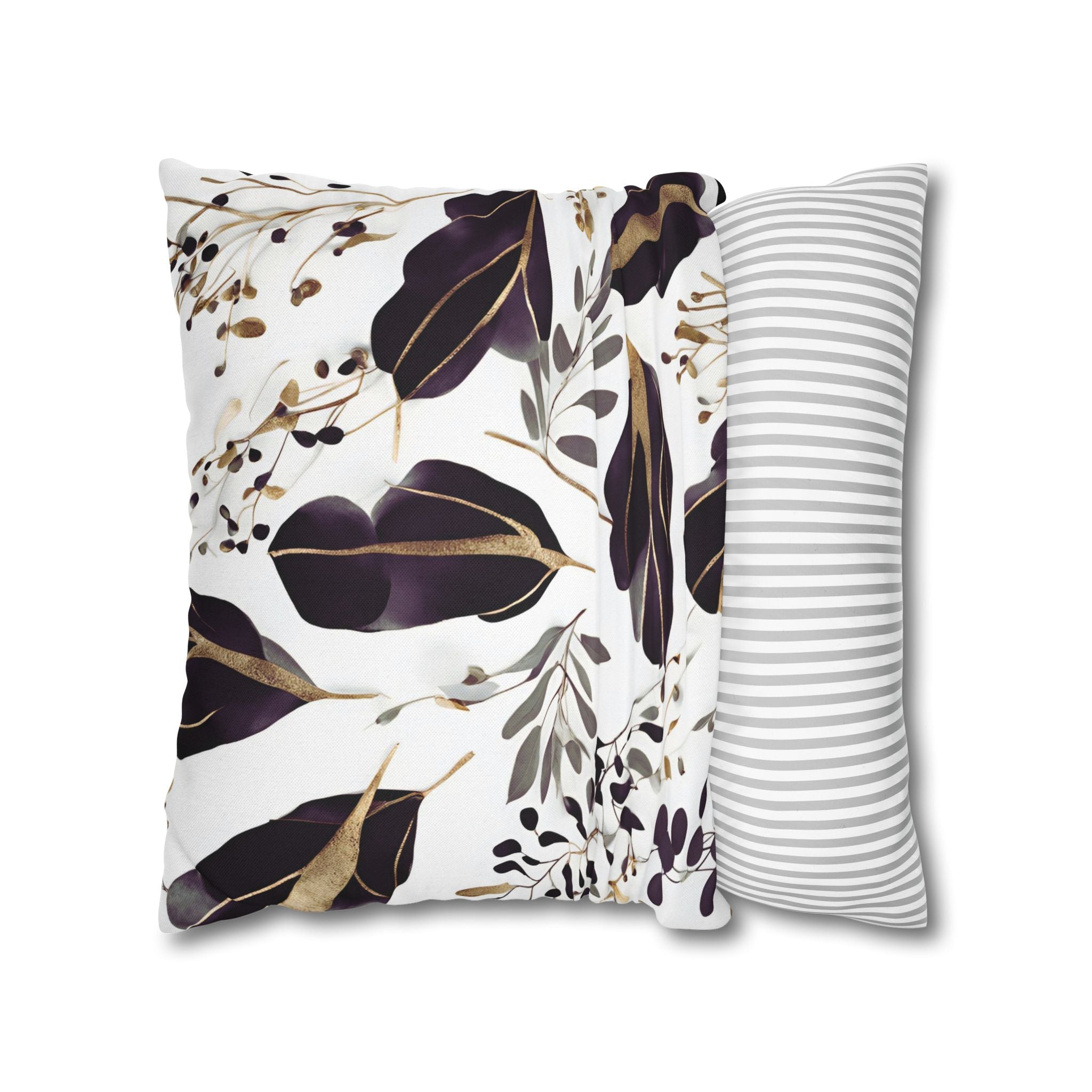 a decorative pillow with a floral pattern in shades of purple and gold.