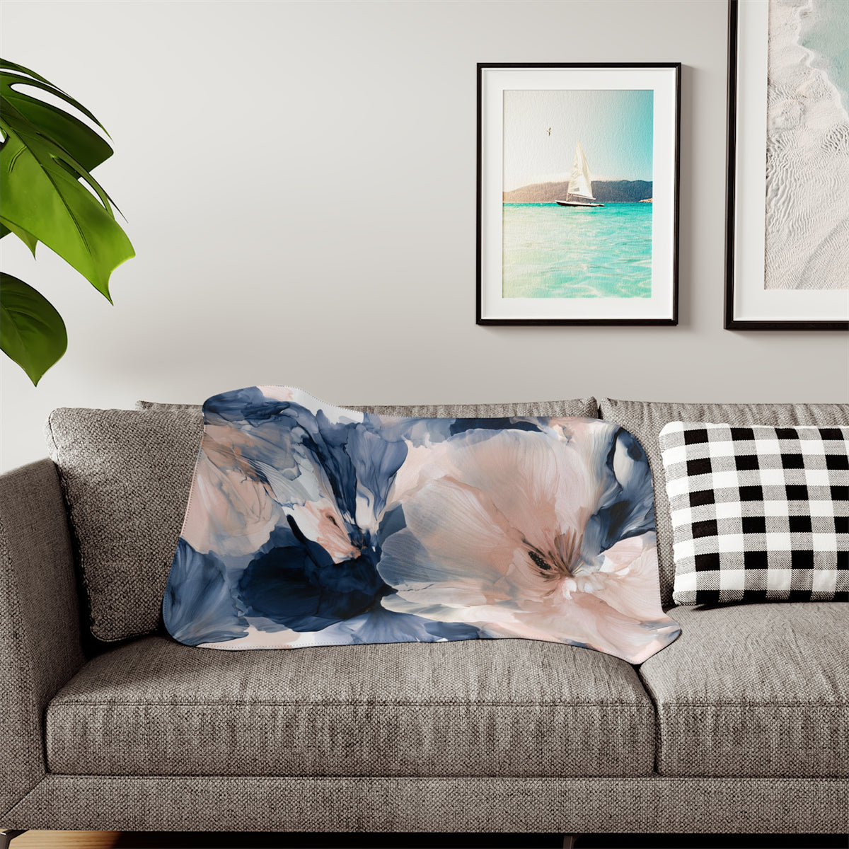 a living room with a gray couch and two pictures on the wall
