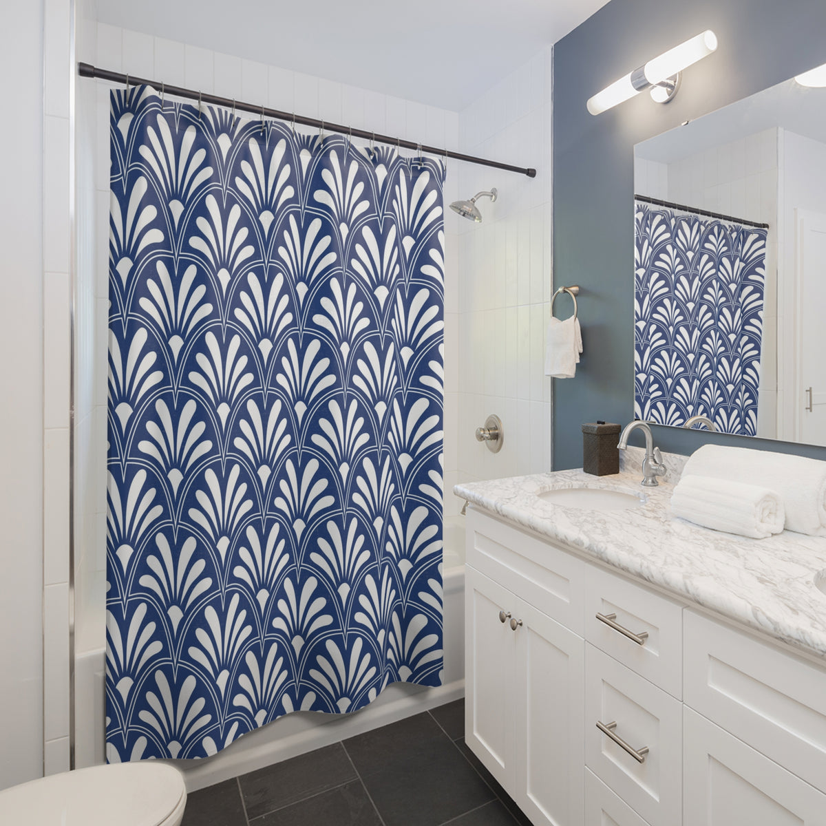 a modern bathroom with a white vanity, a blue and white patterned shower curtain, and a white sink with a marble countertop.