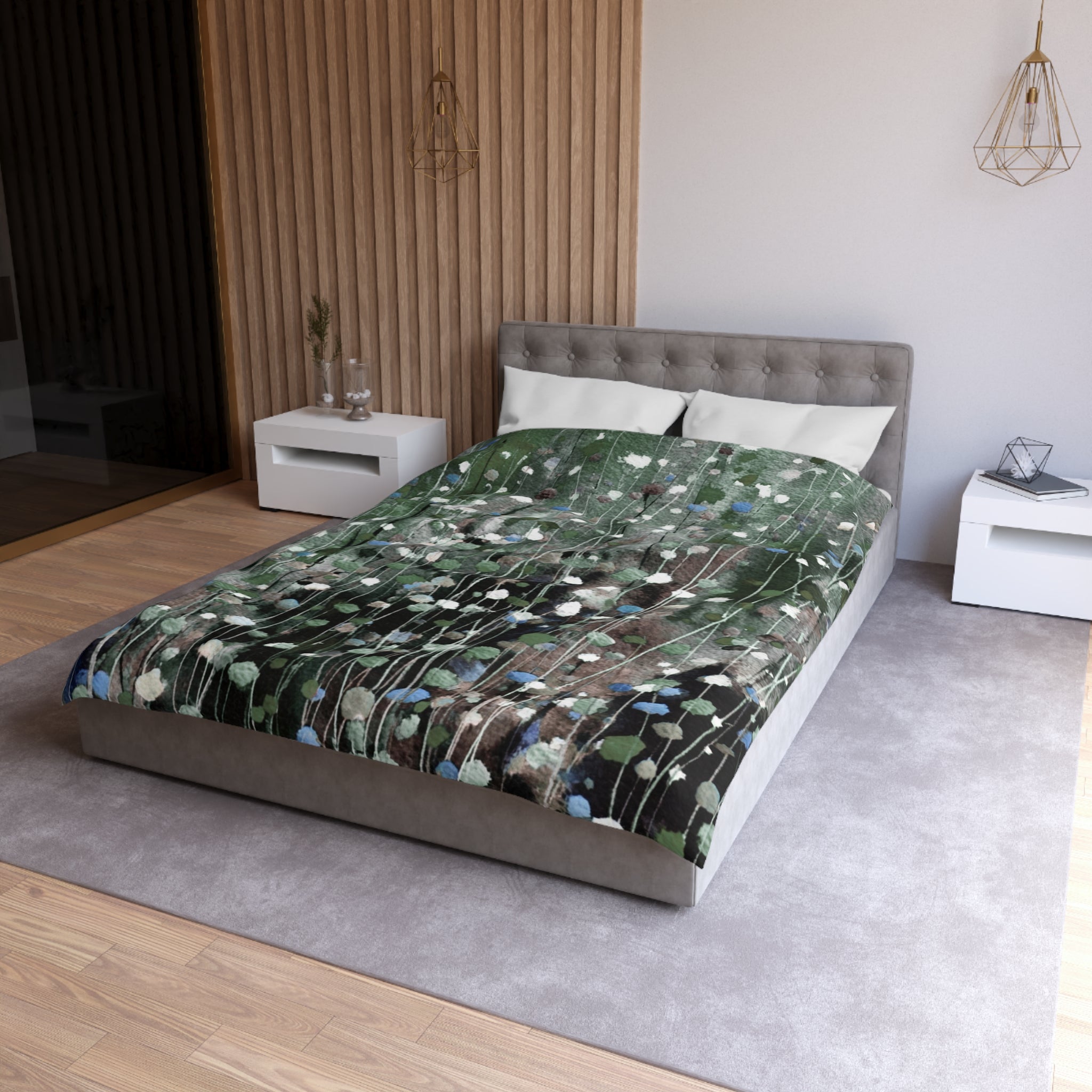 a modern bedroom with a large bed, a gray headboard, and a green and white patterned comforter. The room has a neutral color scheme with white walls and a gray carpet. There are two nightstands on either side of the bed, and a pendant light hangs above the bed.