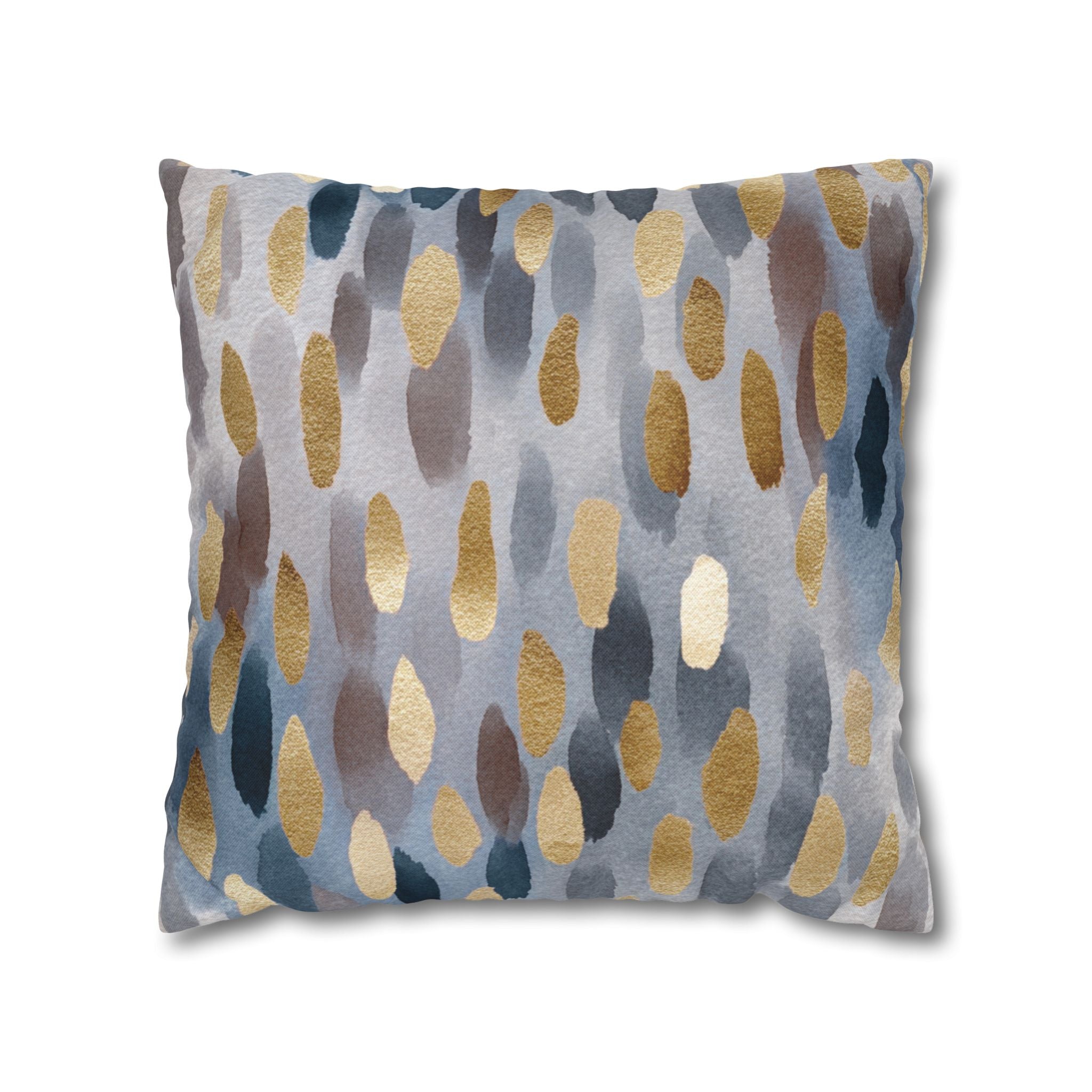 a square pillow with a pattern of gold and gray dots on a white background.