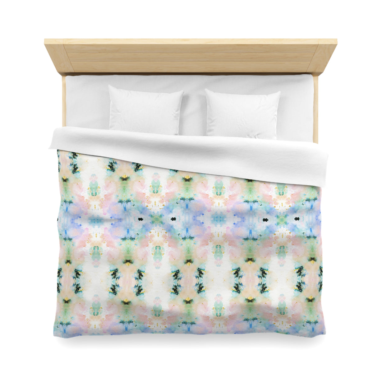 a bed with a colorful, abstract patterned comforter and pillows.
