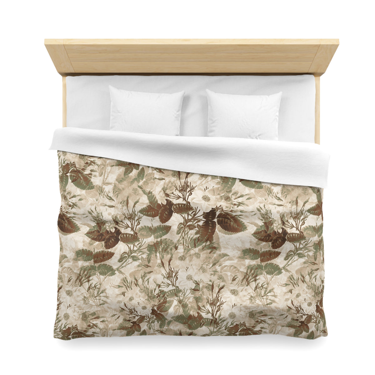 a neatly made bed with a floral print comforter and two white pillows.