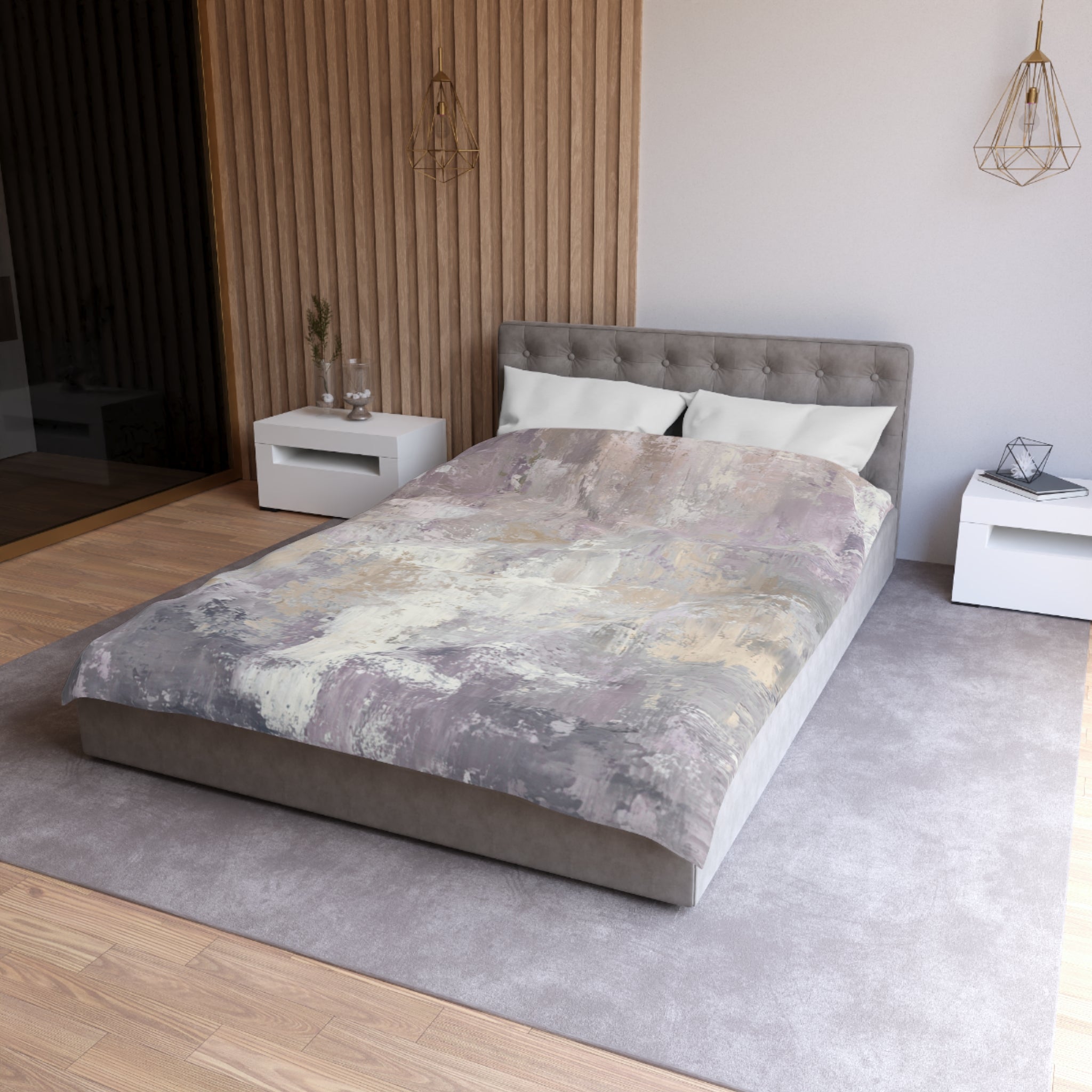 a modern bedroom with a large bed, a gray headboard, and a gray and white patterned comforter. The room has a neutral color scheme with a gray carpet and white walls. There are two nightstands on either side of the bed, and a pendant light hangs above the bed.