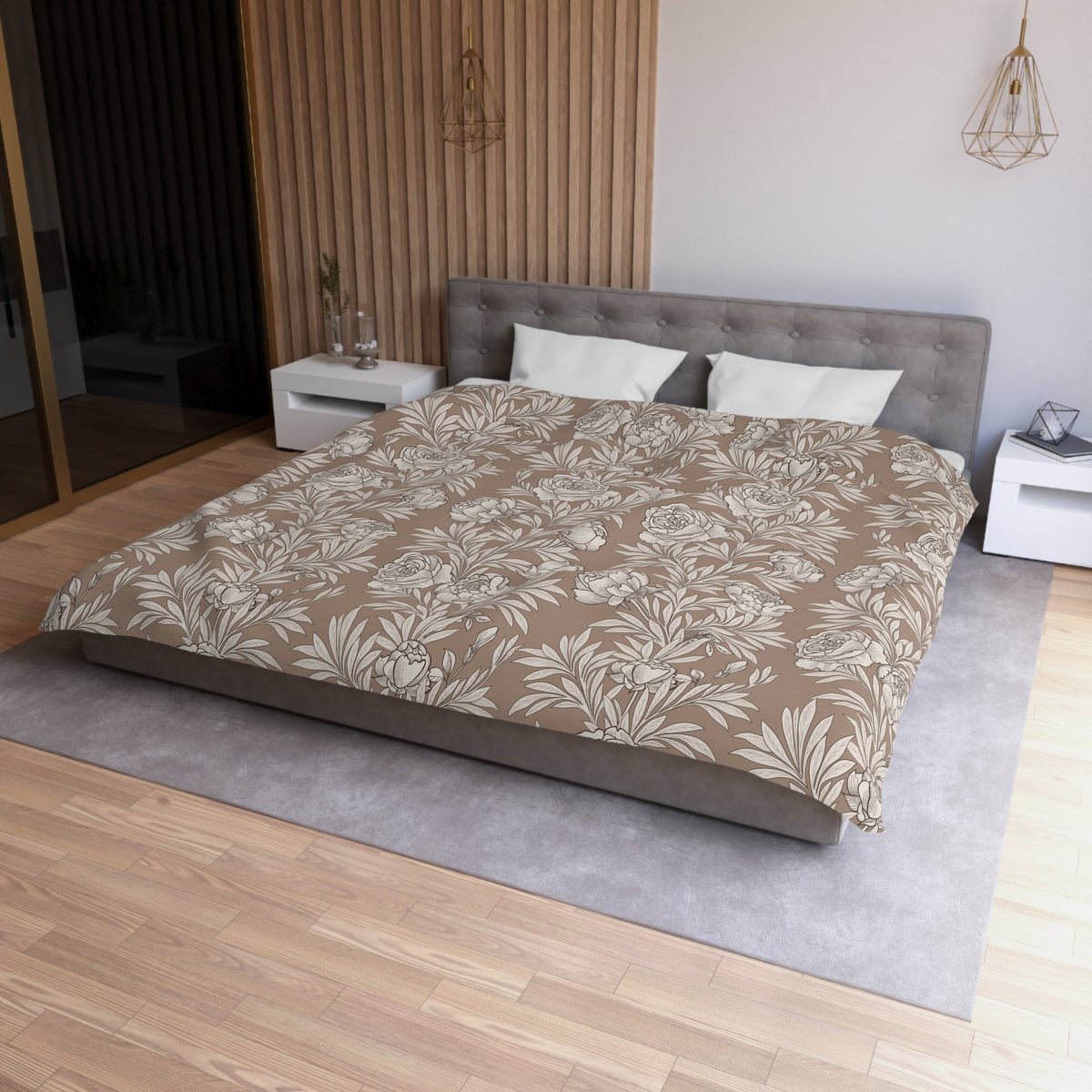a modern bedroom with a large bed, a gray headboard, and a wooden wall. The bed is covered in a floral print comforter, and there are two white pillows on it. The room has a wooden floor and a gray area rug. There are also two nightstands on either side of the bed, and a pendant light hanging above the bed.