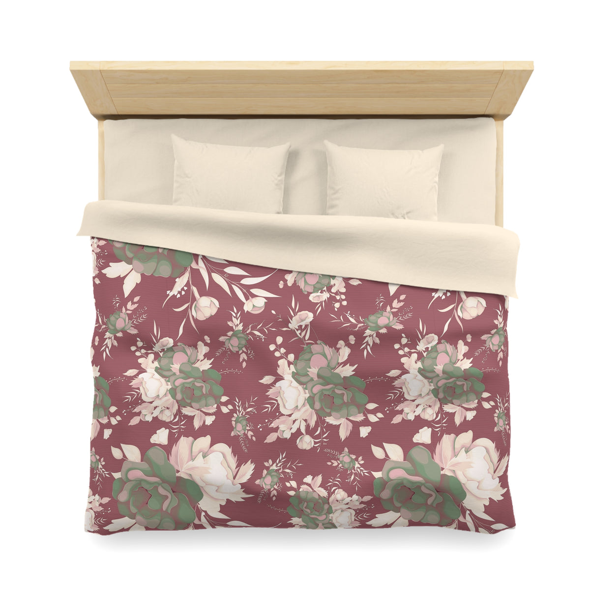 a bed with a floral patterned comforter and pillows.