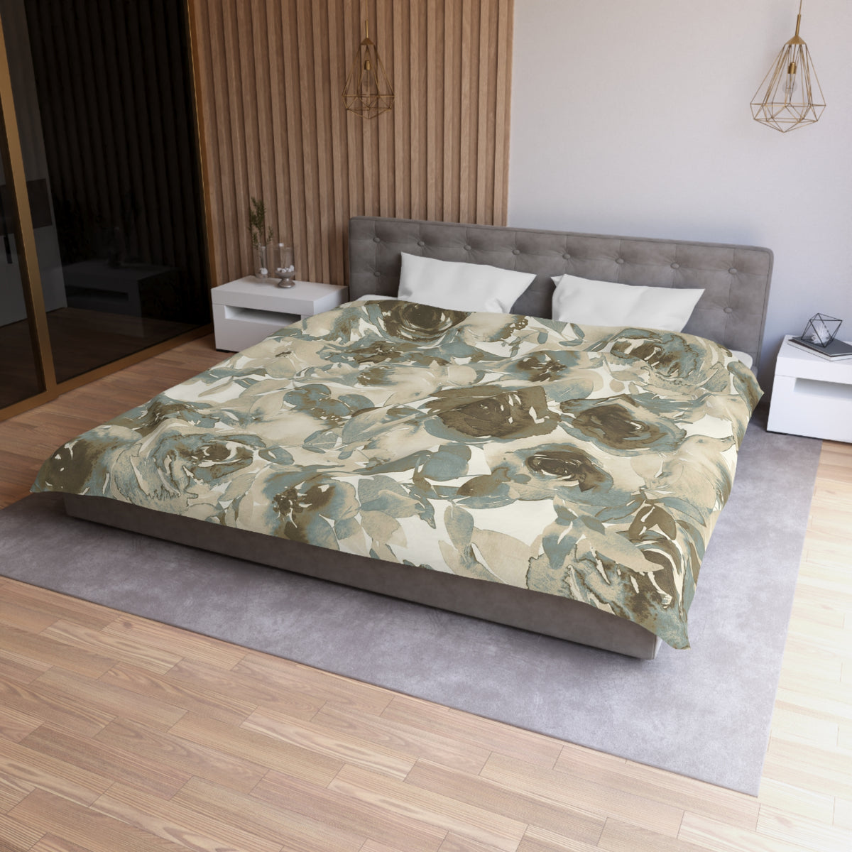 a modern bedroom with a large bed, a gray headboard, and a floral print bedspread. The room has a wooden floor and white walls, creating a serene and elegant atmosphere.