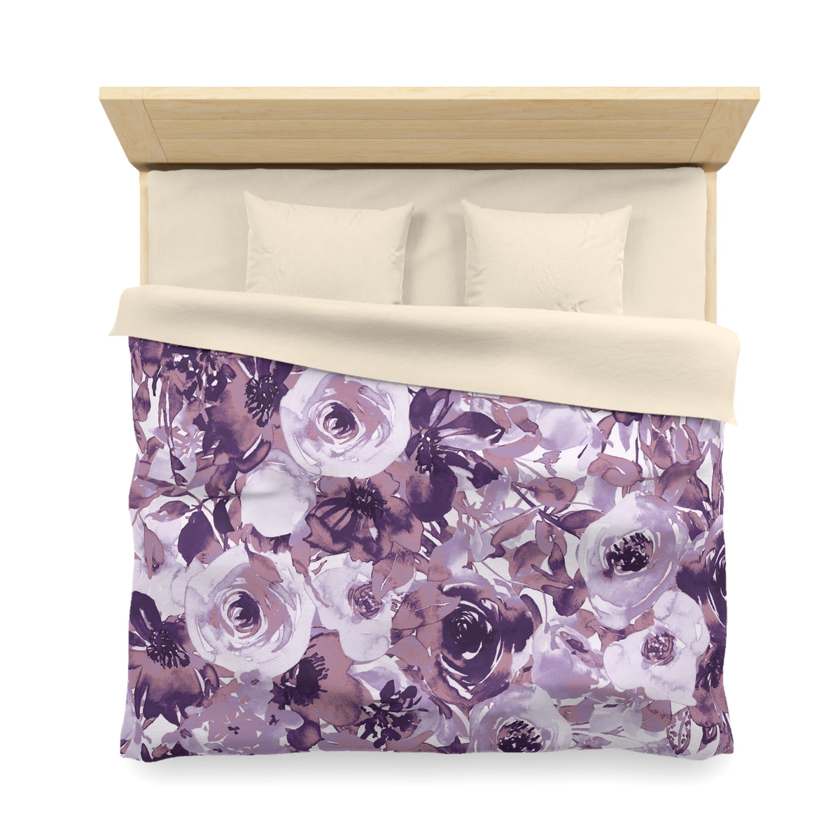 a bed with a floral print duvet cover and pillows.