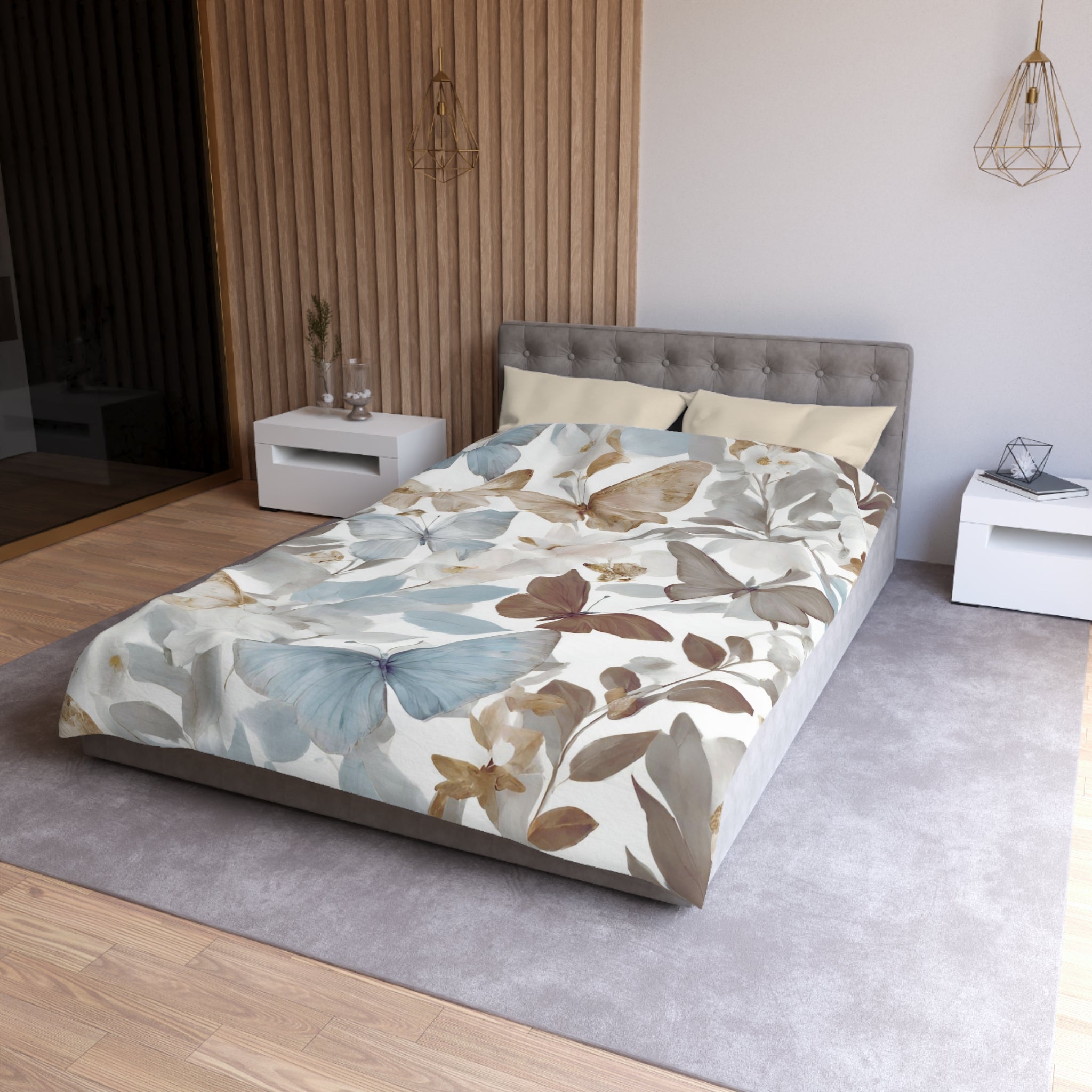 a modern bedroom with a gray tufted headboard, a white bedside table, and a gray area rug. The bed is covered in a comforter with a floral print in shades of blue, green, and brown.