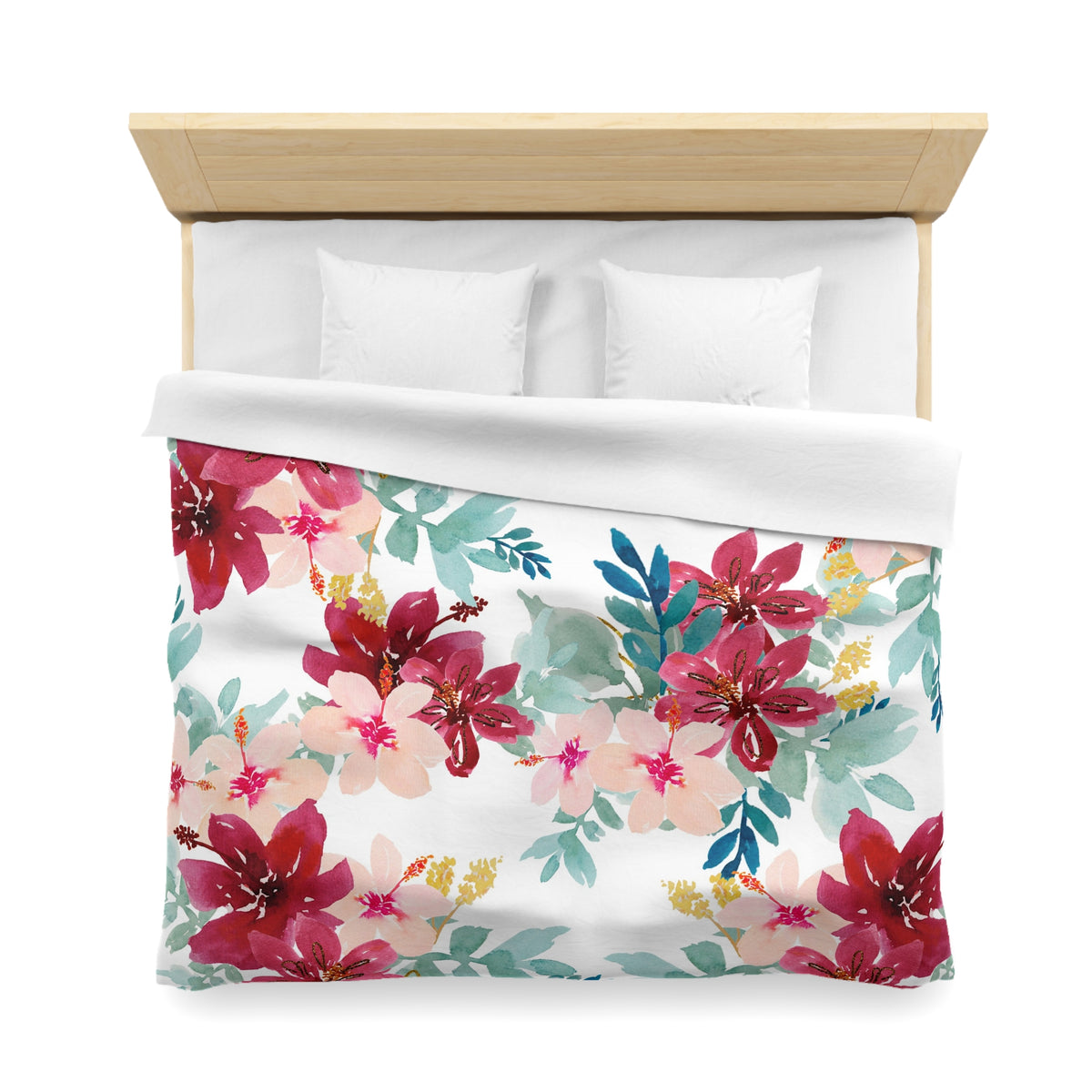 a bed with a floral print duvet cover and pillows.