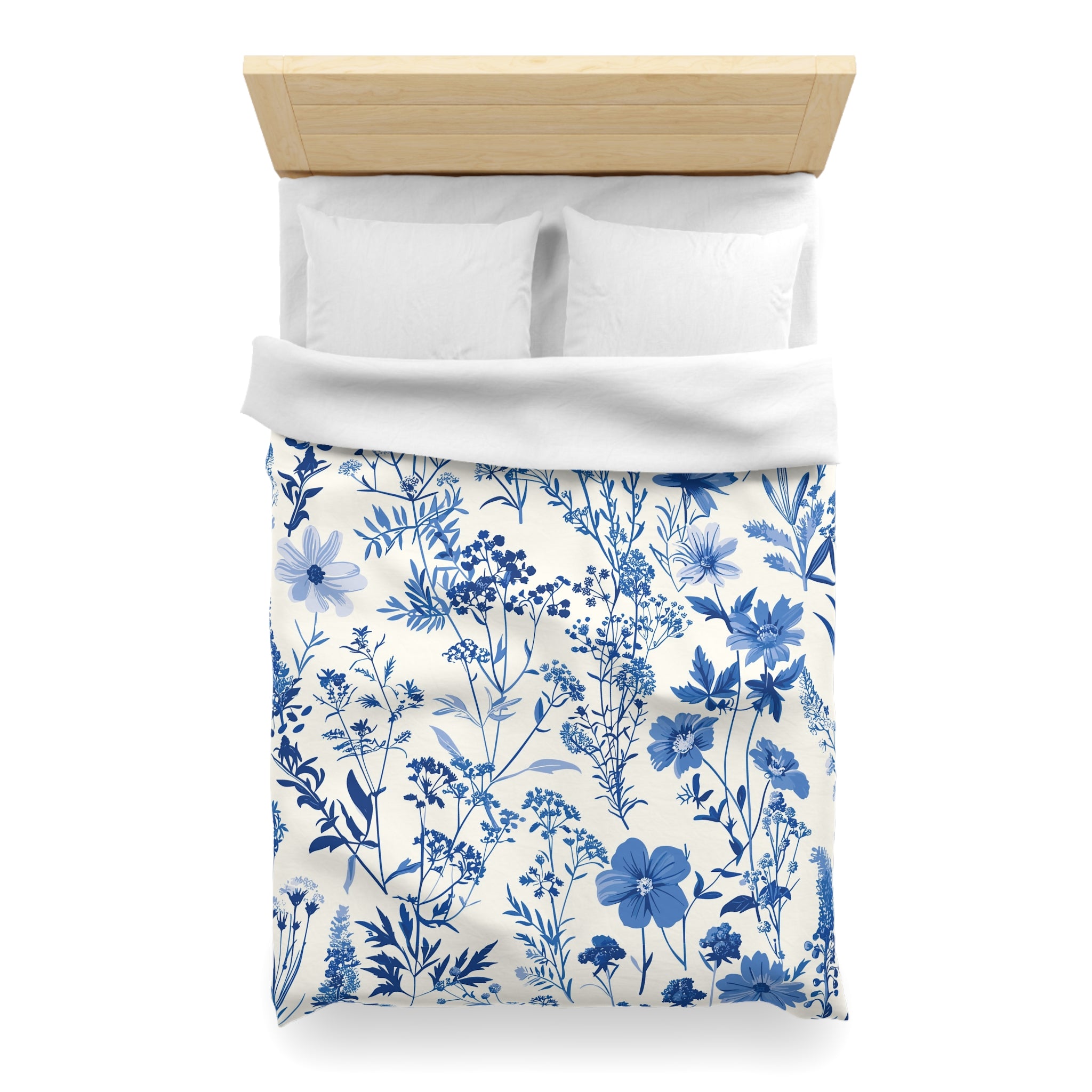a neatly made bed with a blue and white floral patterned comforter and pillows.