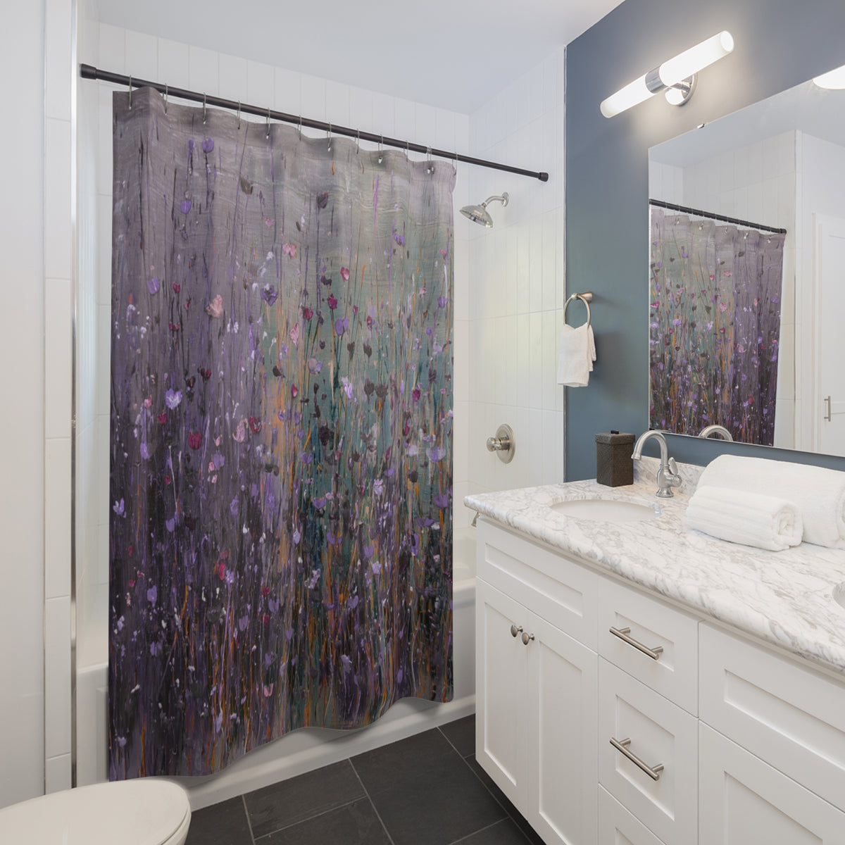 a modern bathroom with a white vanity, a shower curtain with a floral pattern, and a mirror above the vanity.