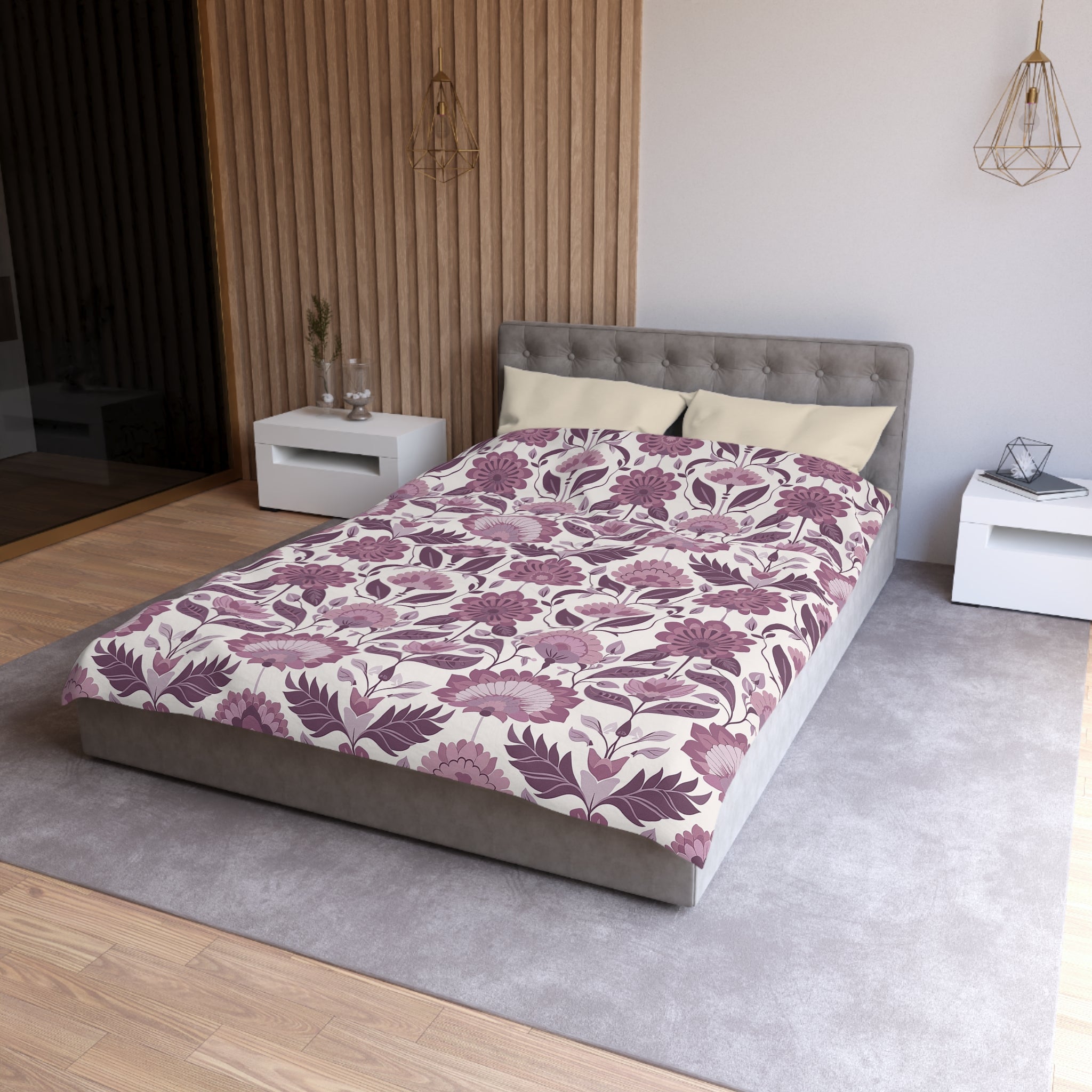 a modern bedroom with a gray tufted headboard, a floral patterned comforter, and two white nightstands.
