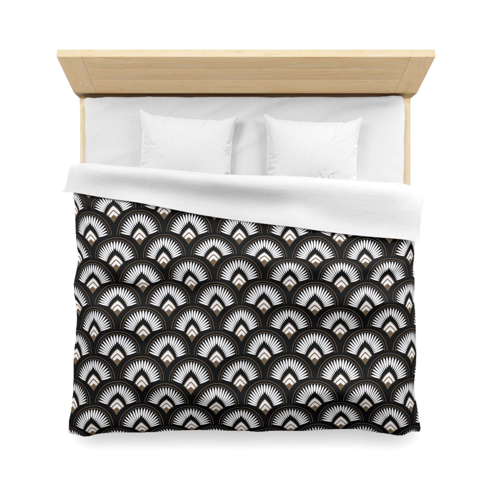 a neatly made bed with a black and white patterned comforter and two white pillows.