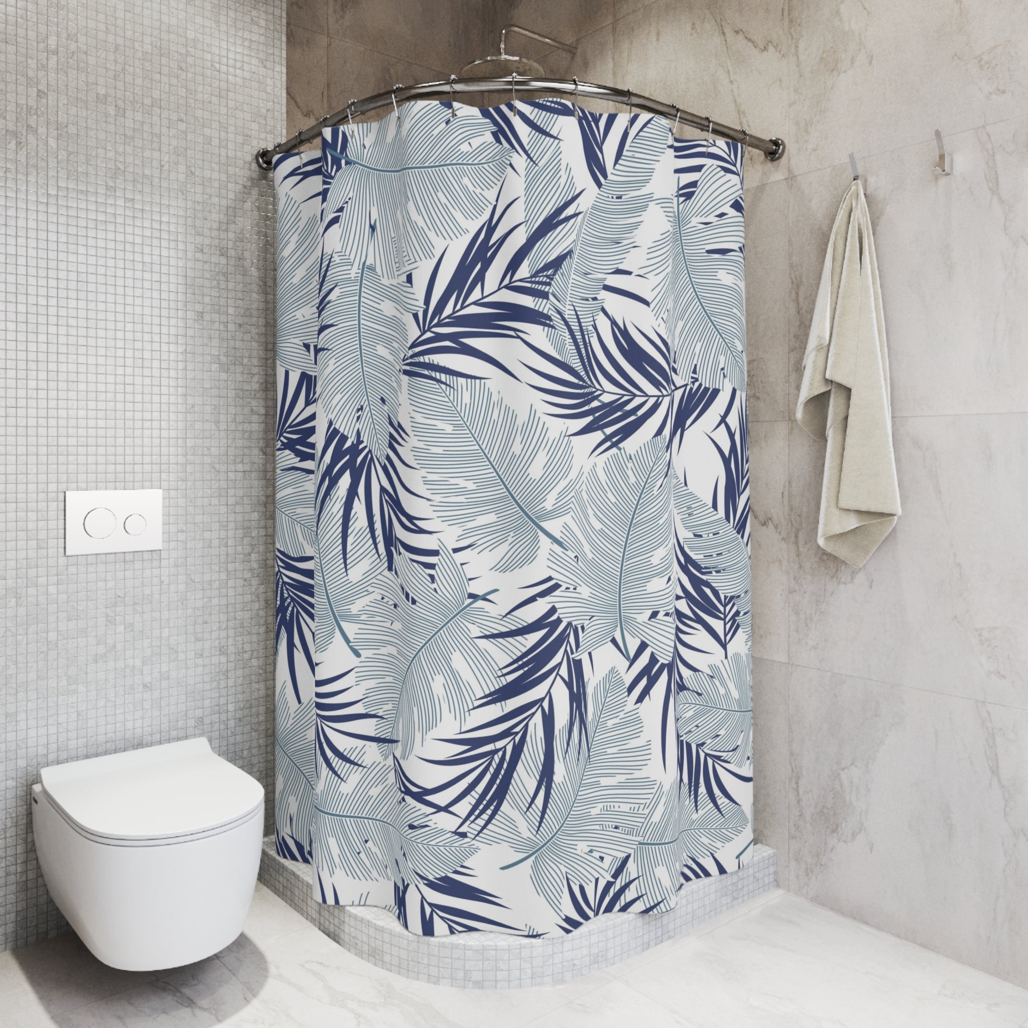 a bathroom with a shower curtain adorned with a tropical leaf pattern in shades of blue and white. The shower curtain is hanging from a rod, and there is a towel hanging on the wall next to it. The bathroom has a white toilet and a tiled wall, creating a clean and modern aesthetic.