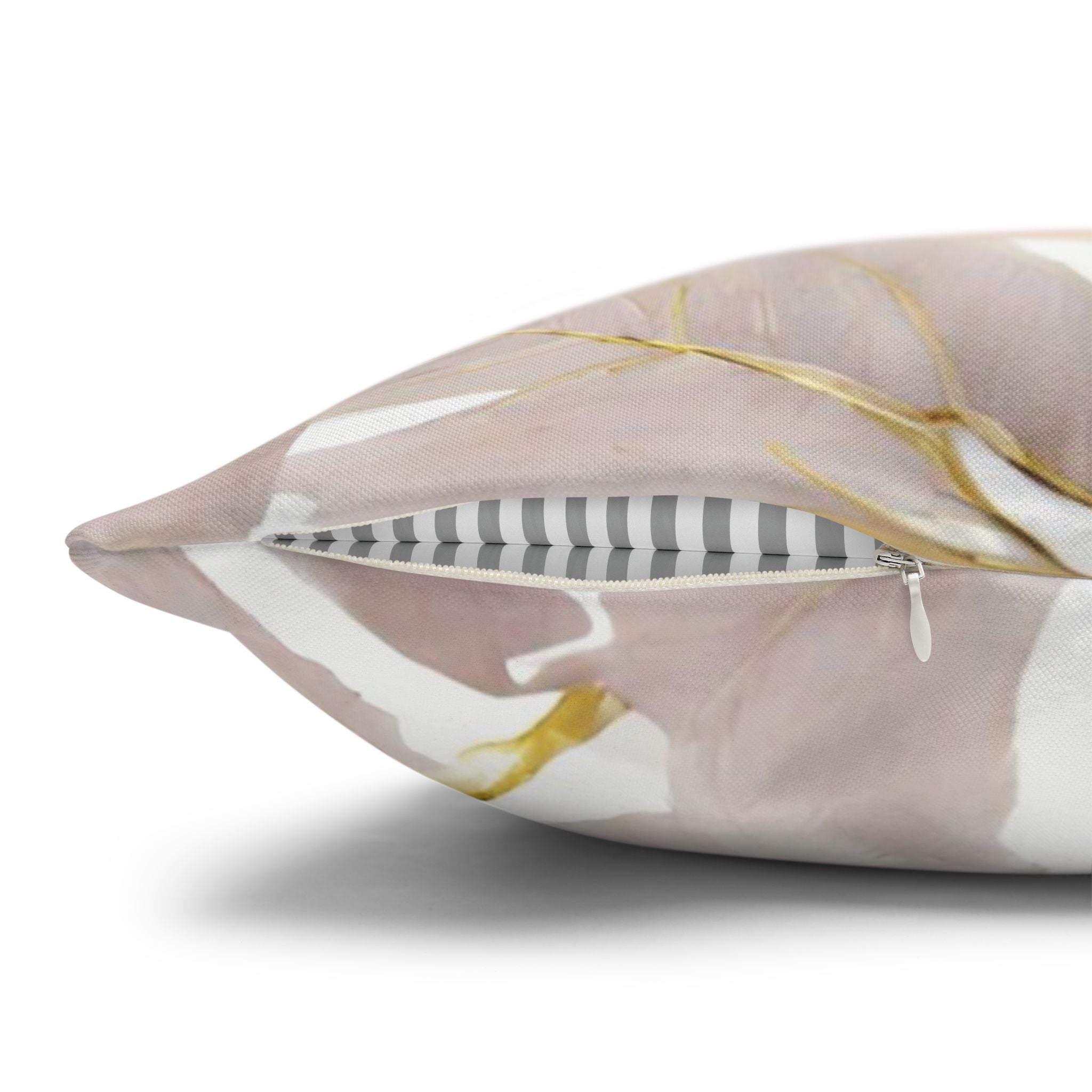 A close-up view of a decorative pillow with a floral pattern and a zipper.
