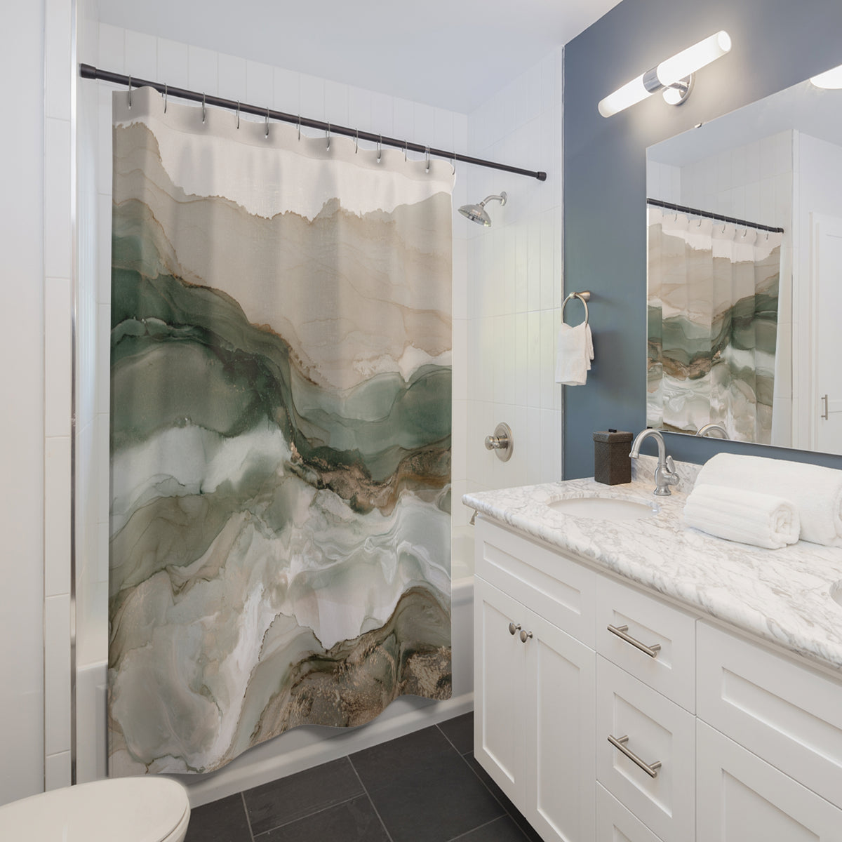 A modern bathroom with a white vanity, marble countertop, and a shower curtain featuring a marble-like pattern in shades of green and beige.