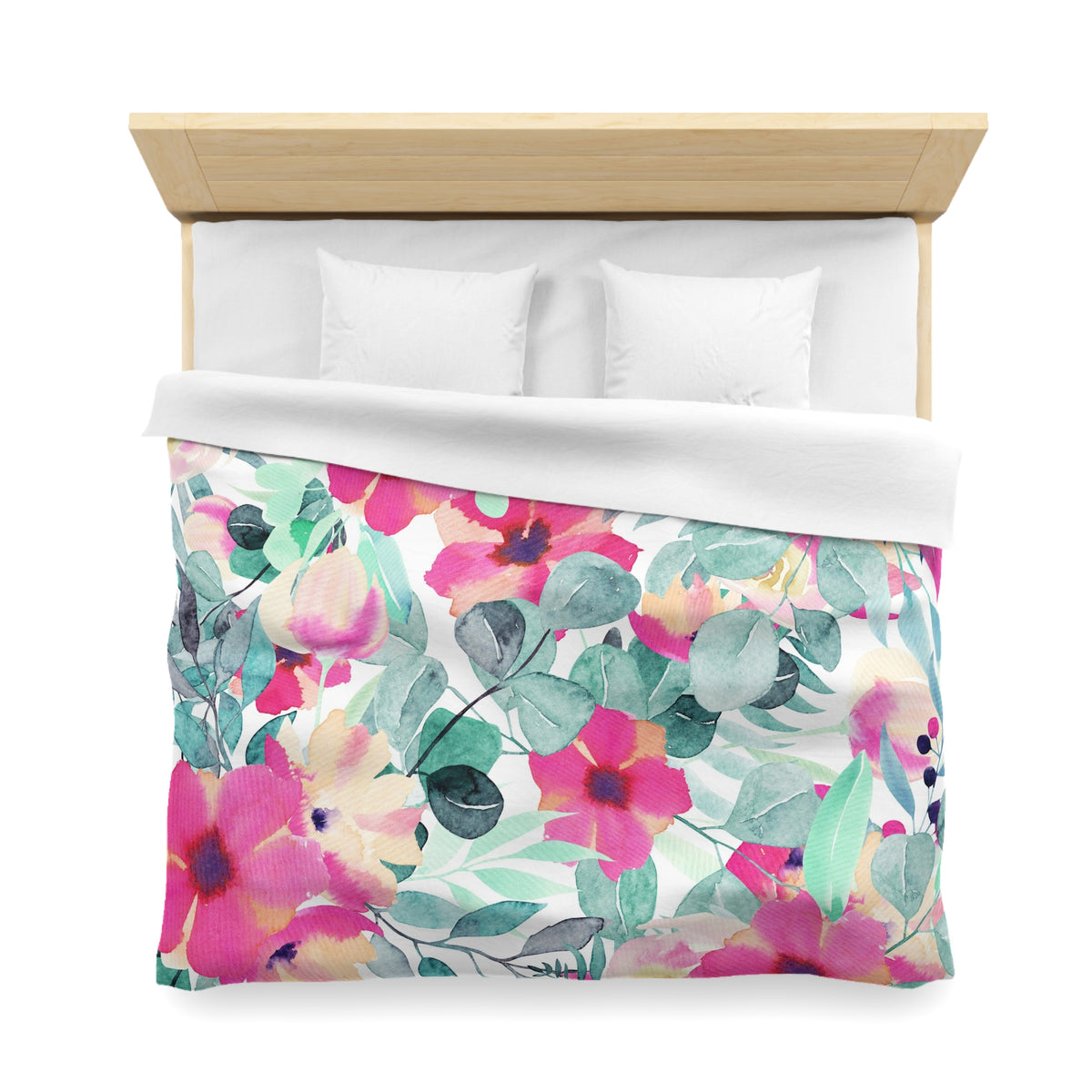 a bed with a floral print duvet cover and pillows.