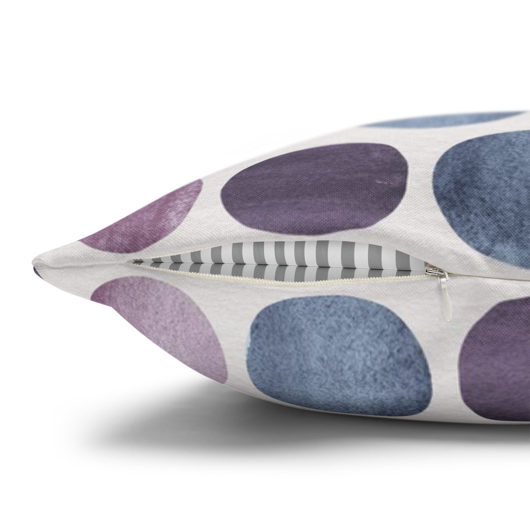 a close-up view of a pillow with a pattern of purple and blue circles on a white background.