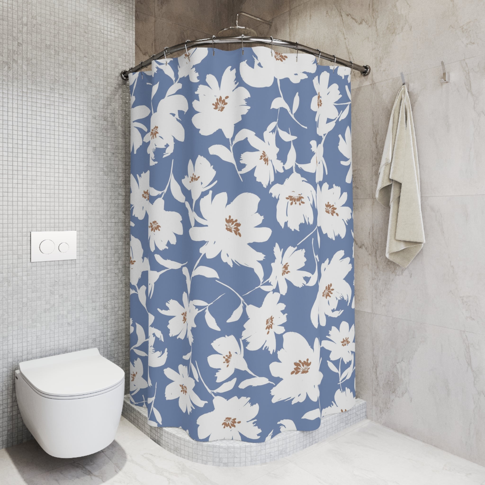 a bathroom with a shower curtain featuring a floral pattern in shades of blue and white. The shower curtain is hanging from a rod, and there is a towel hanging on the wall next to it. The bathroom also includes a toilet and a tiled wall.