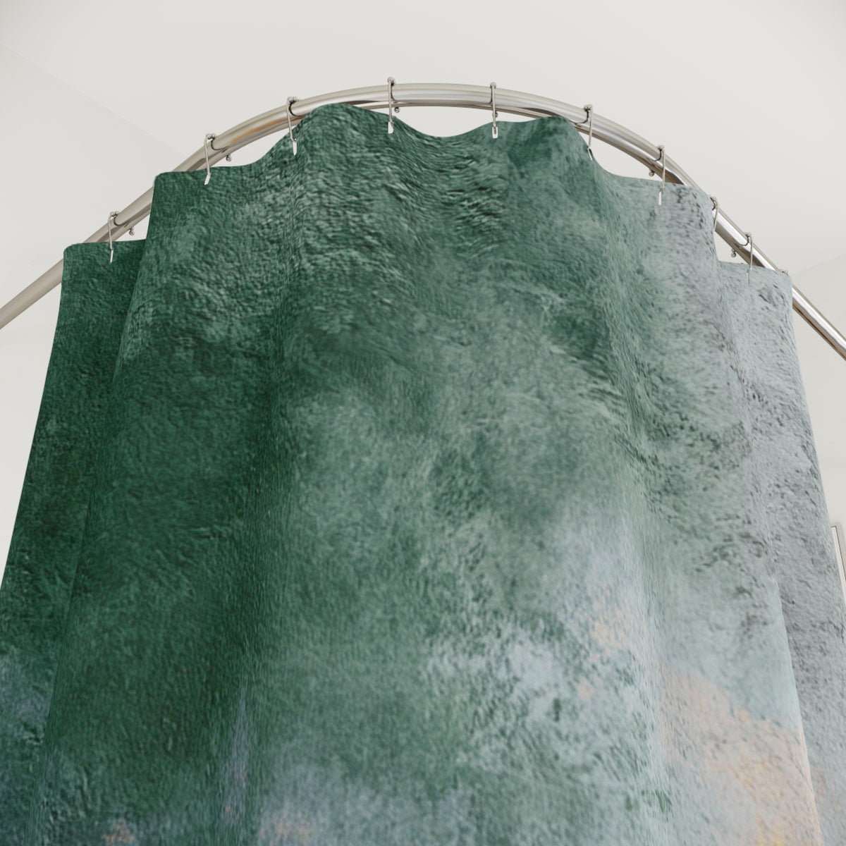 a green and gray patterned curtain hanging from a curved metal rod.