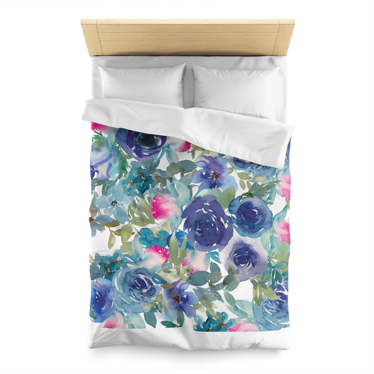 a bed with a floral print duvet cover featuring a variety of blue and pink flowers.