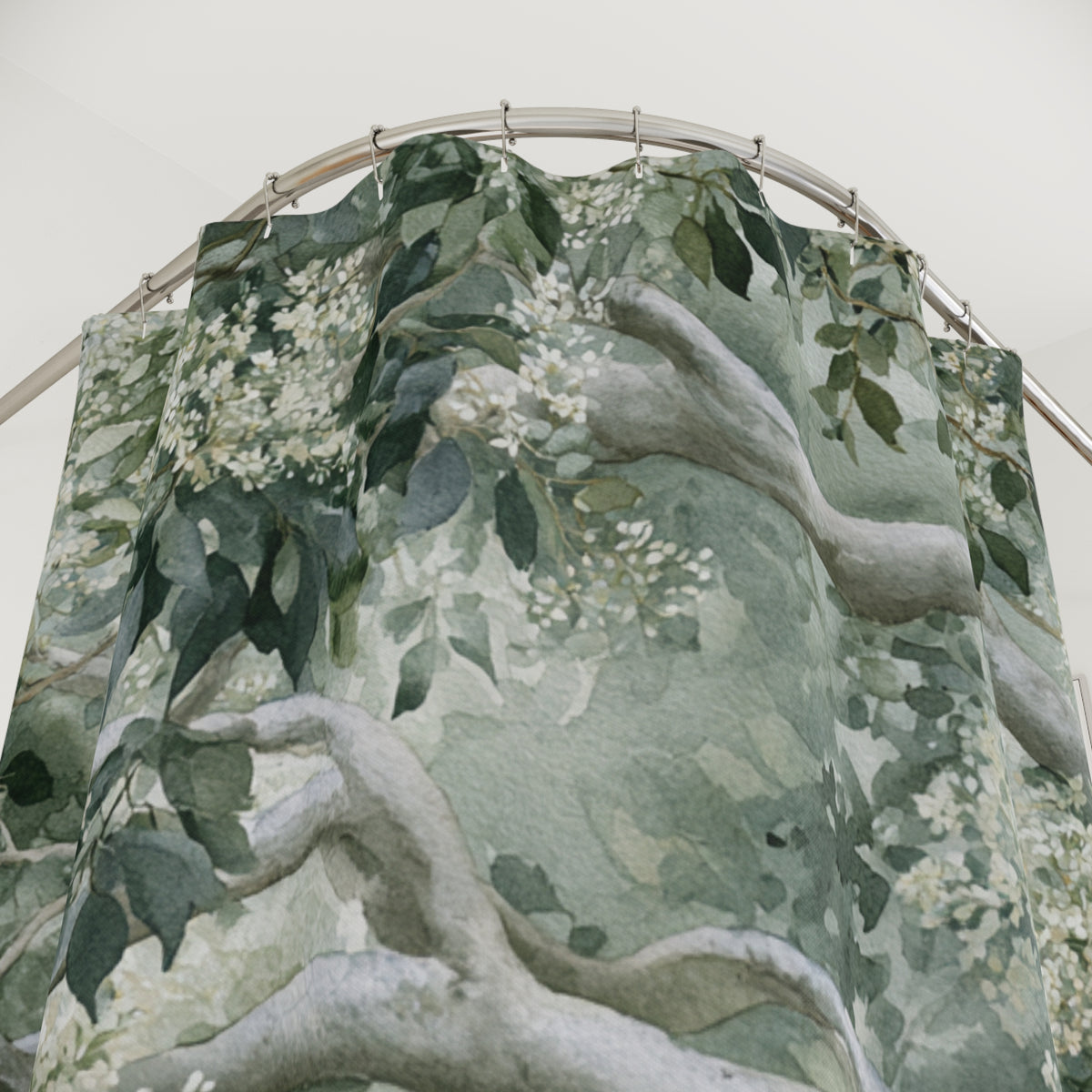 a shower curtain with a green and white floral pattern.