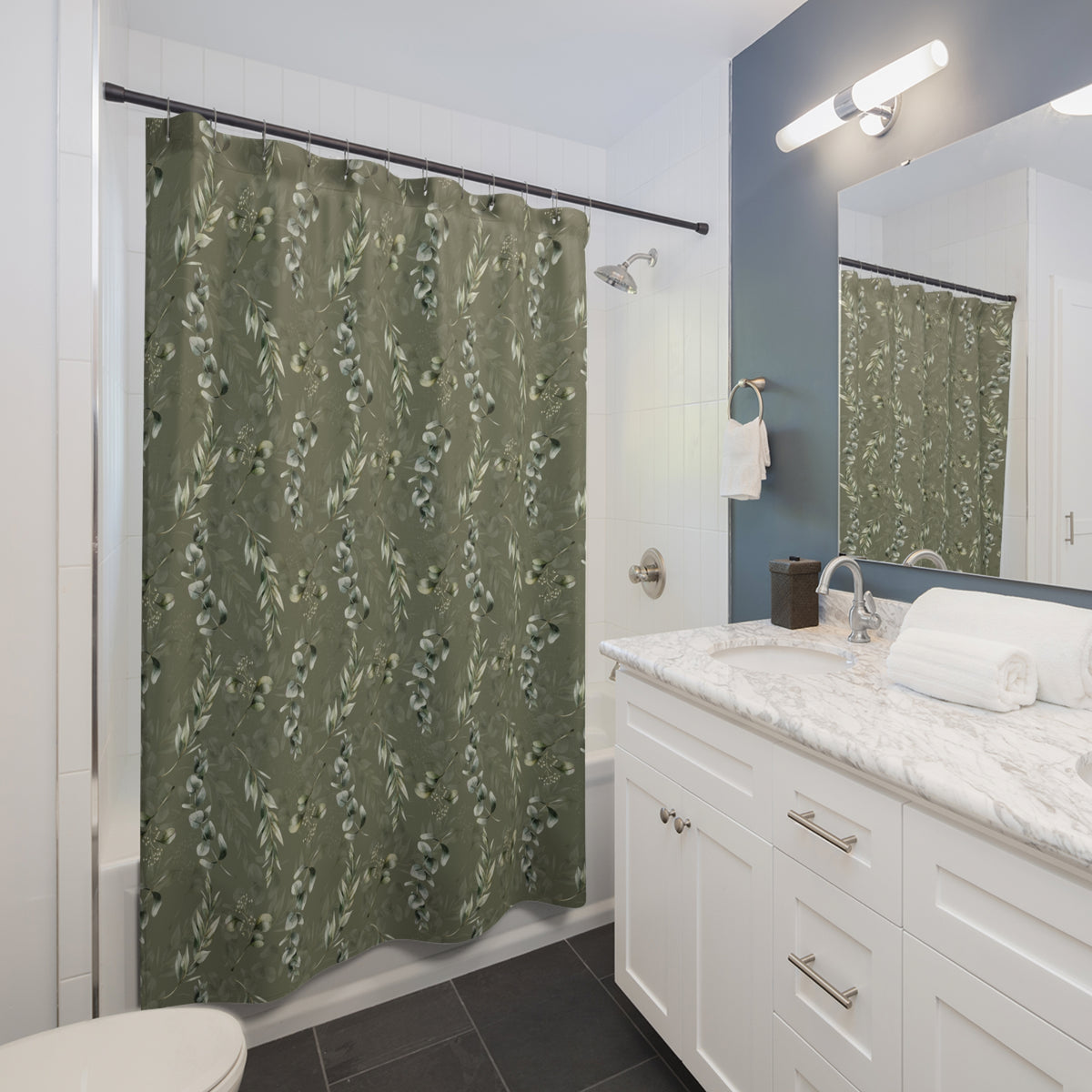 a modern bathroom with a white vanity, a green shower curtain with a floral pattern, and a white sink with a marble countertop.