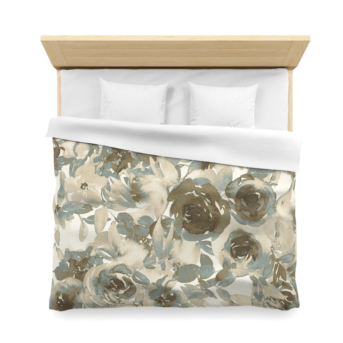 a neatly made bed with a floral print duvet cover and two white pillows.