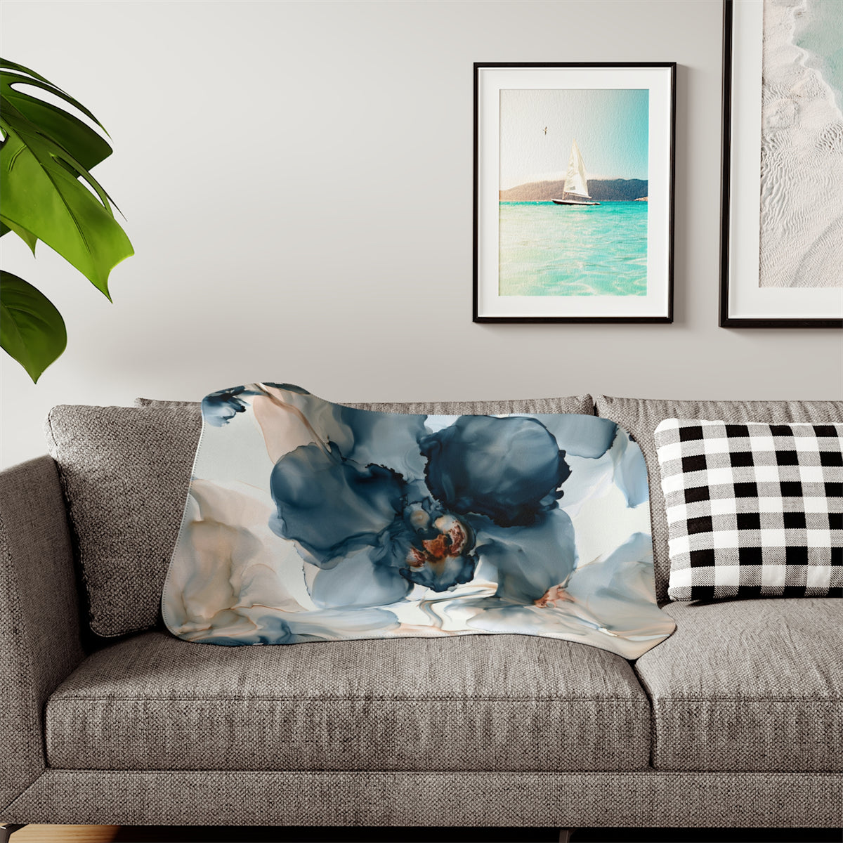 a living room with a couch and two pictures on the wall
