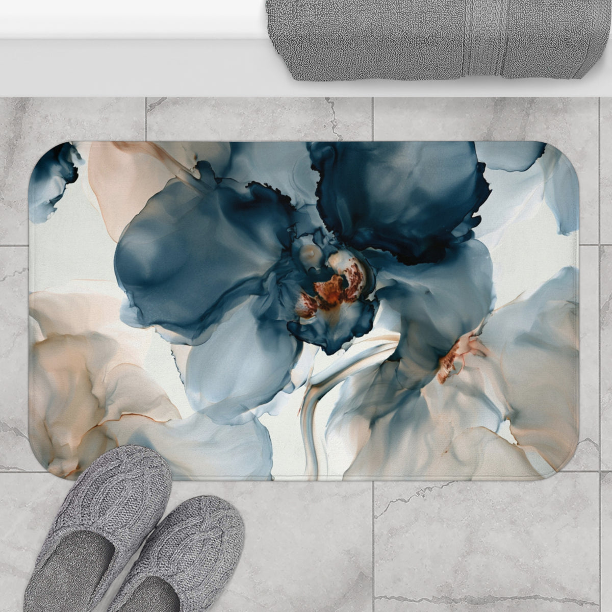 a bathroom rug with a blue flower on it