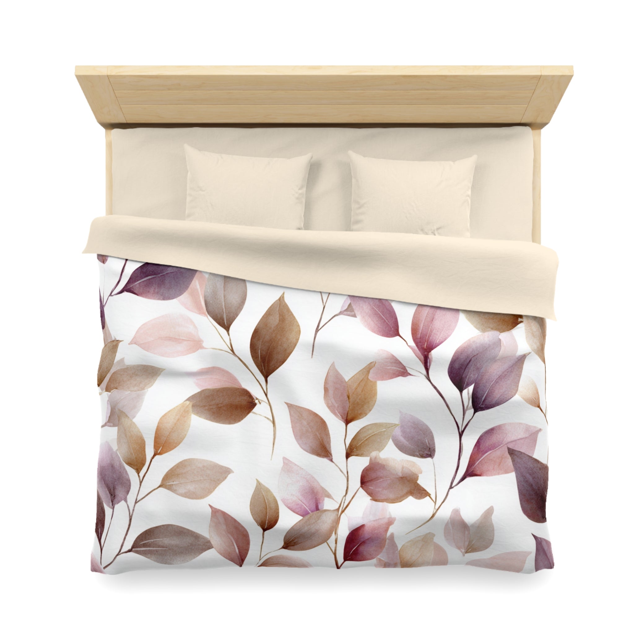 a bed with a white comforter and a patterned duvet cover featuring leaves in shades of pink and brown.