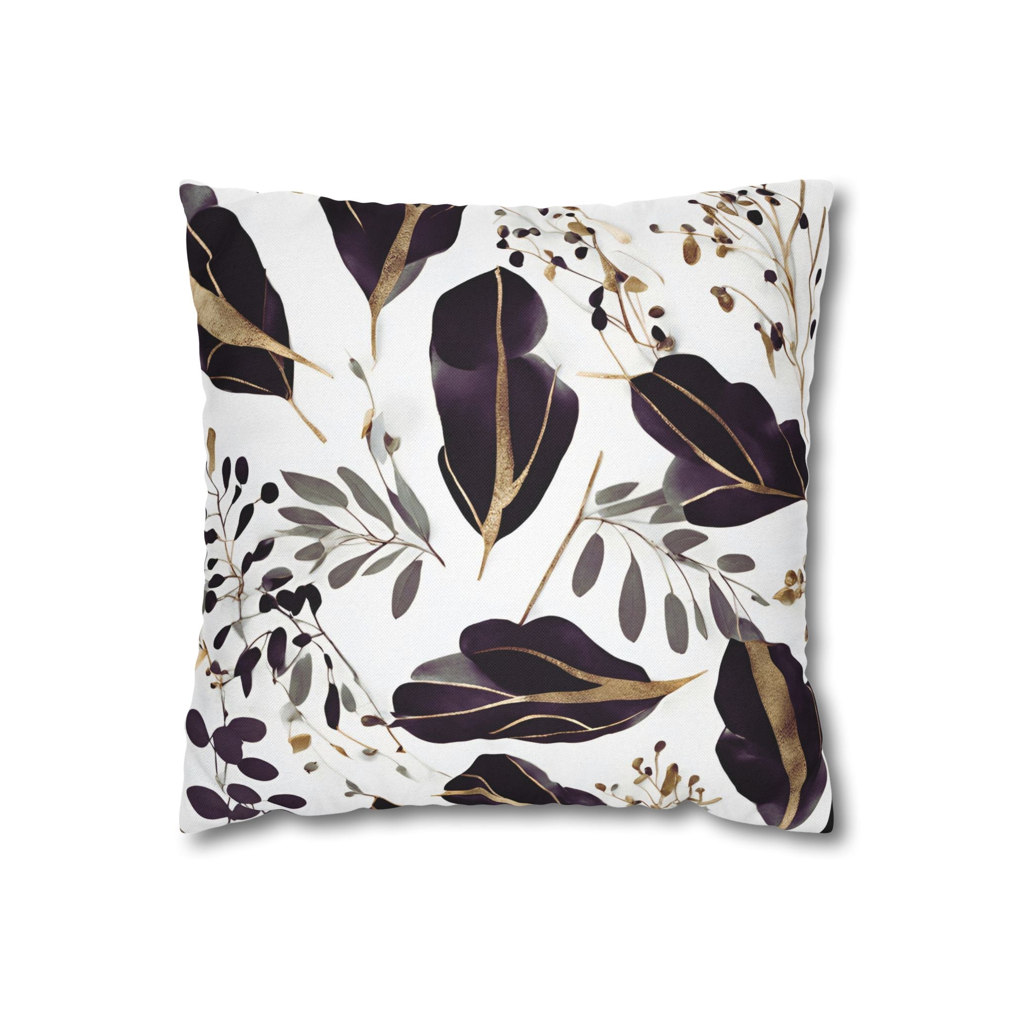 a square pillow with a white background and a repeating pattern of purple and gold leaves and branches.