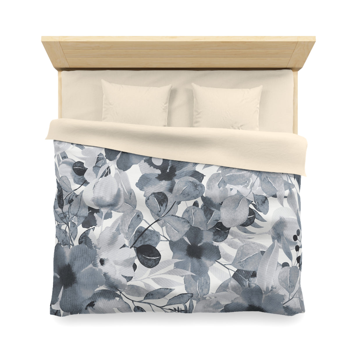 a neatly made bed with a floral print comforter and two pillows.
